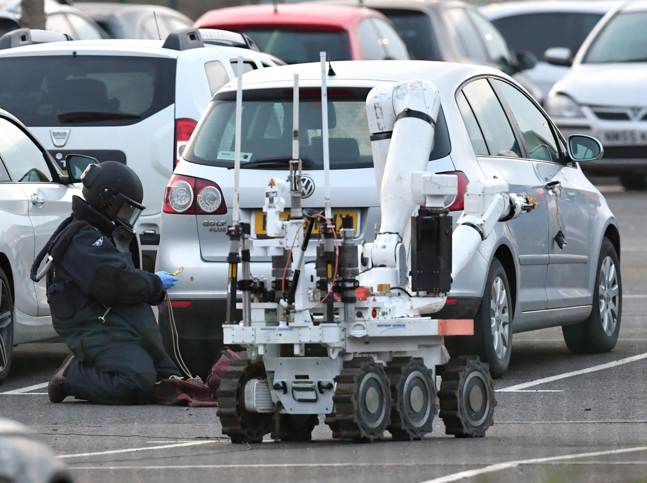 A member of the RAF bomb disposal unit investigates a Volkswagen Golf parked at HMP Peterborough