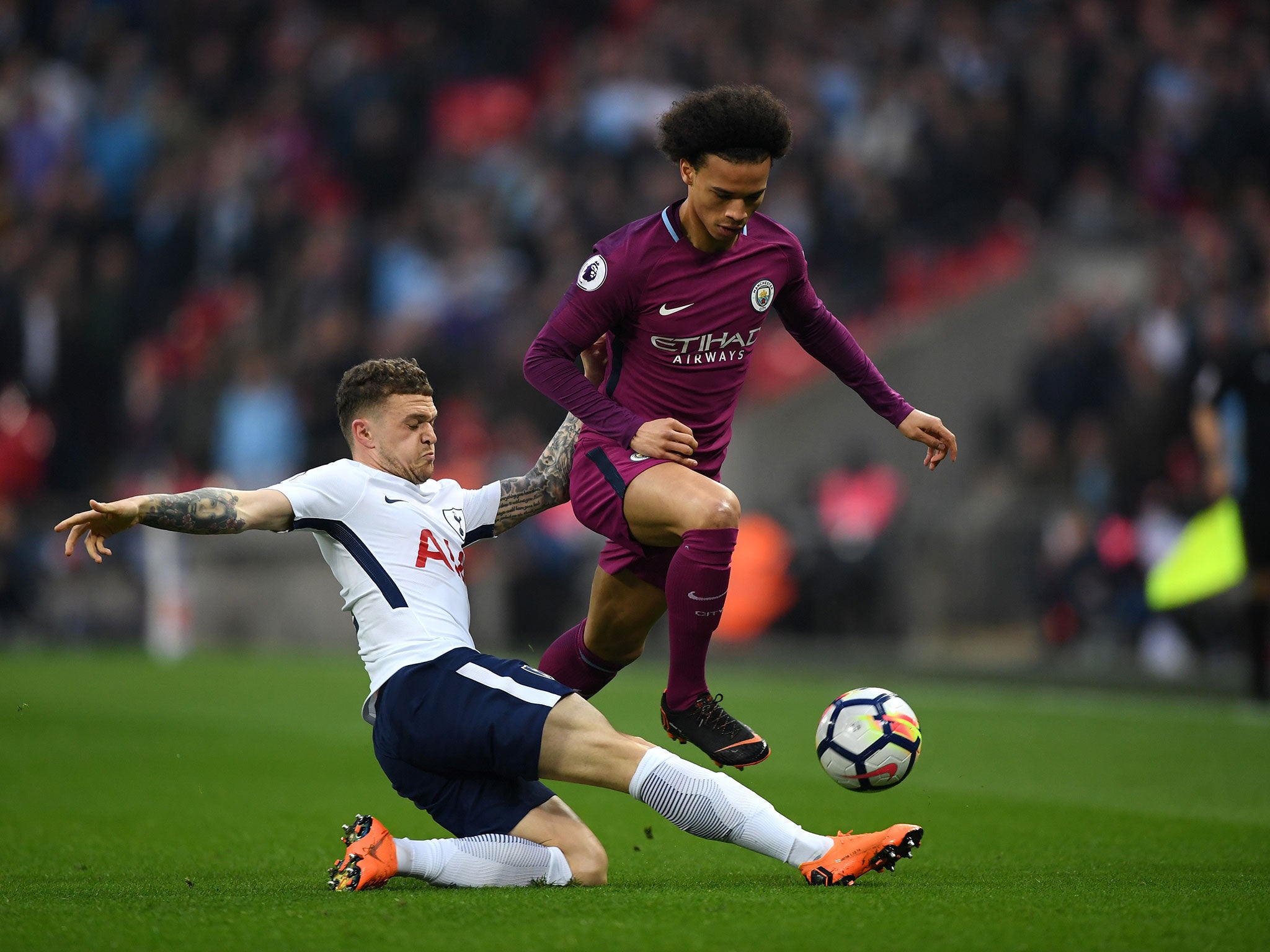 Kieran Trippier attempts to dispossess Leroy Sane with a sliding tackle