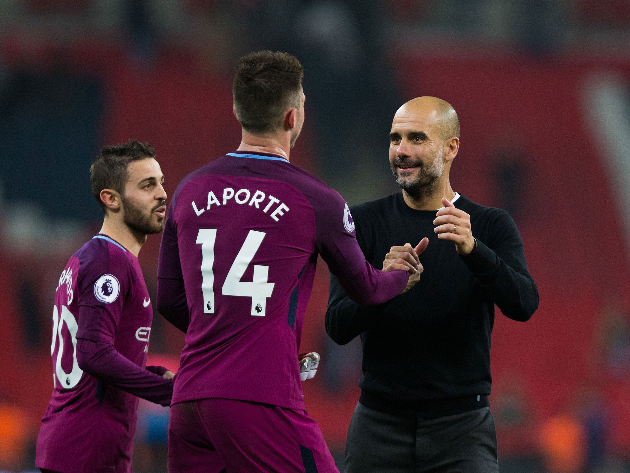 Pep Guardiola celebrates with his players after the final whistle