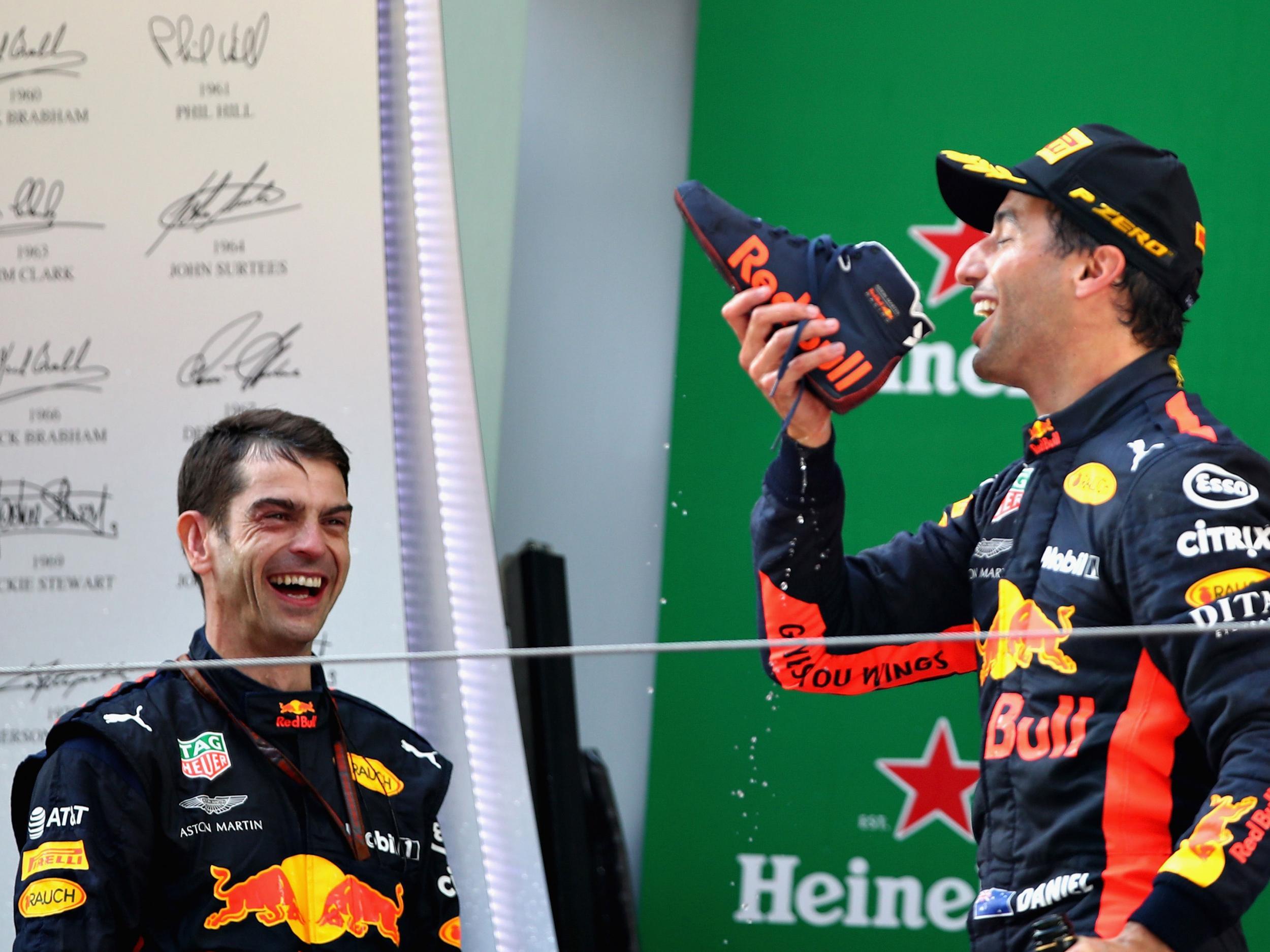 Daniel Ricciardo takes a celebratory drink from his shoe