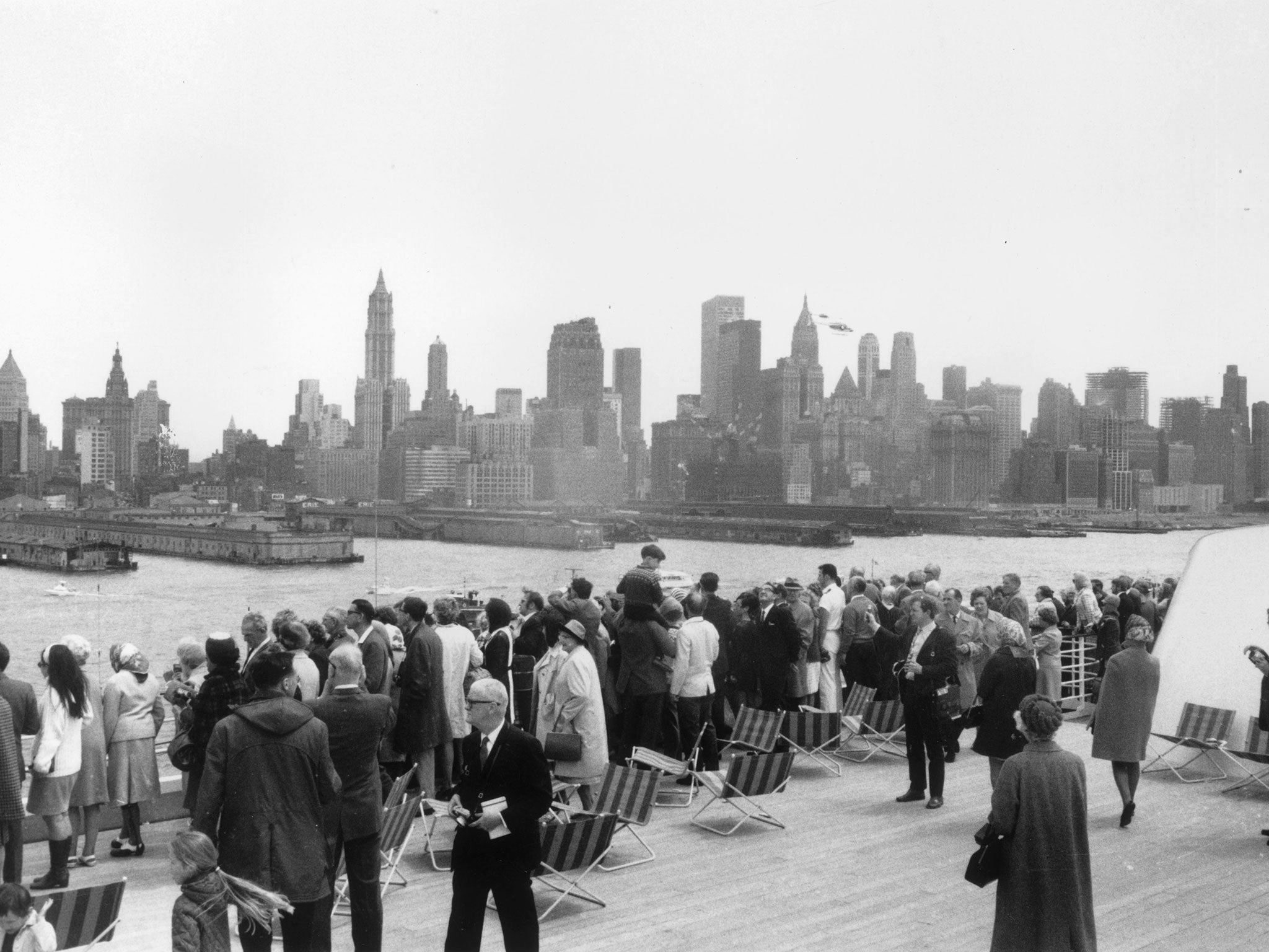 Passengers on the QE2 line the rails as the ship arrives in New York in 1969