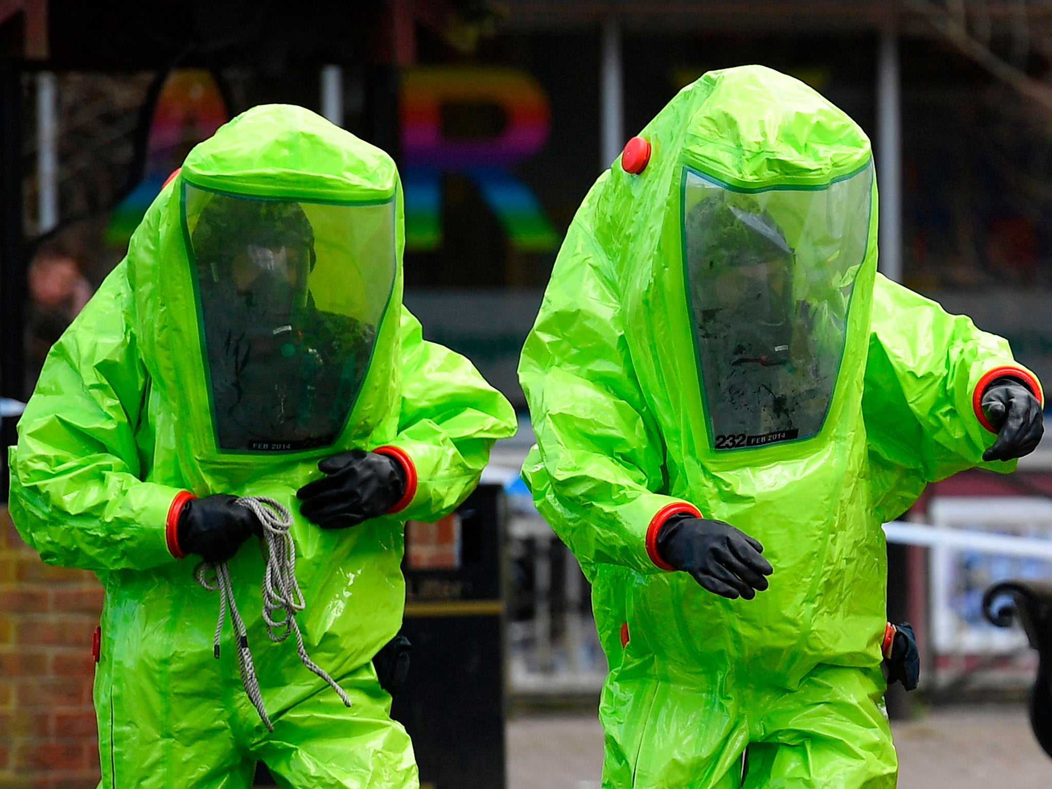 Members of the emergency services in green biohazard suits in Salisbury