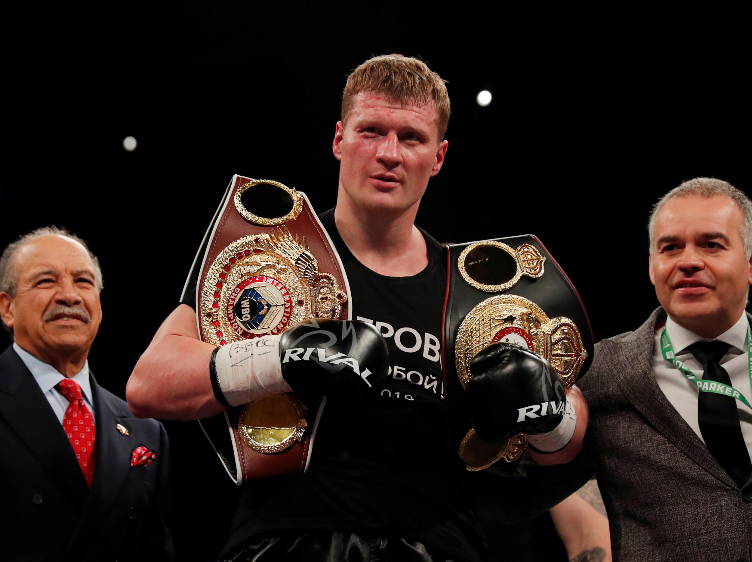 Alexander Povetkin with his WBO and WBA titles