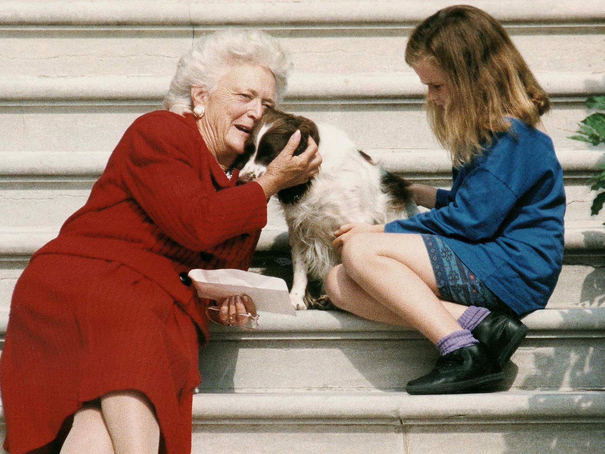 &#13;
First Lady Barbara Bush talking to her dog Millie as she and grandaughter Barbara Bush , age nine, wait for US President George Bush to return to the White House in 1991 (AFP/Getty)&#13;