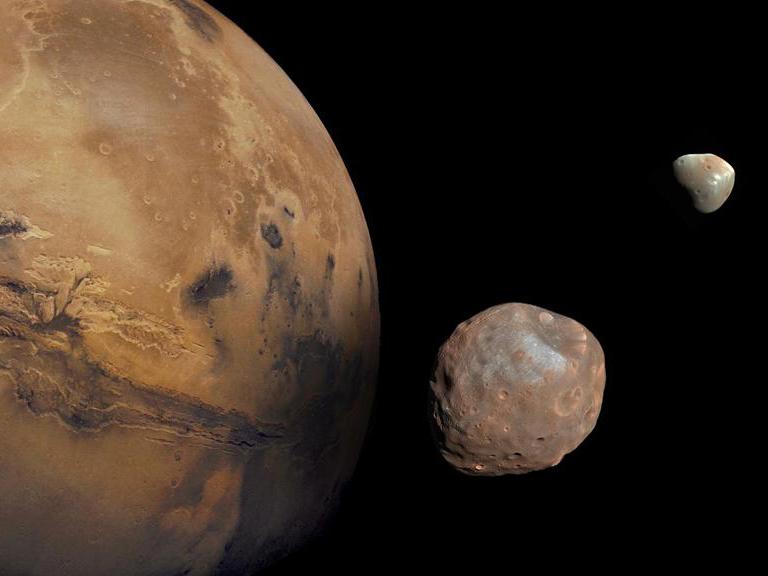 Mars is kept company by two cratered moons -- an inner moon named Phobos and an outer moon named Deimos.