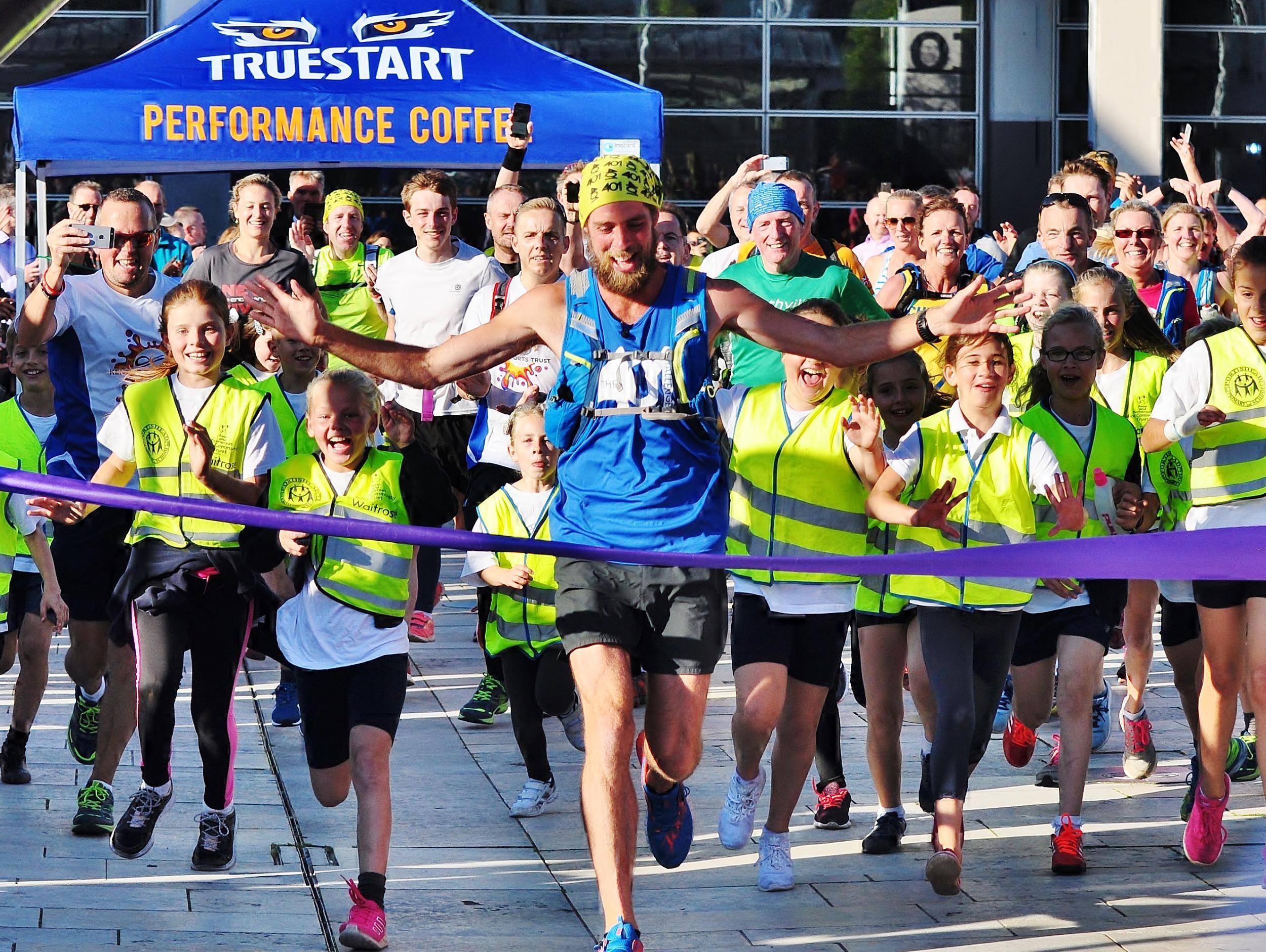 Ben Smith crossing the finishing last of the last race in the 401 marathon challenge