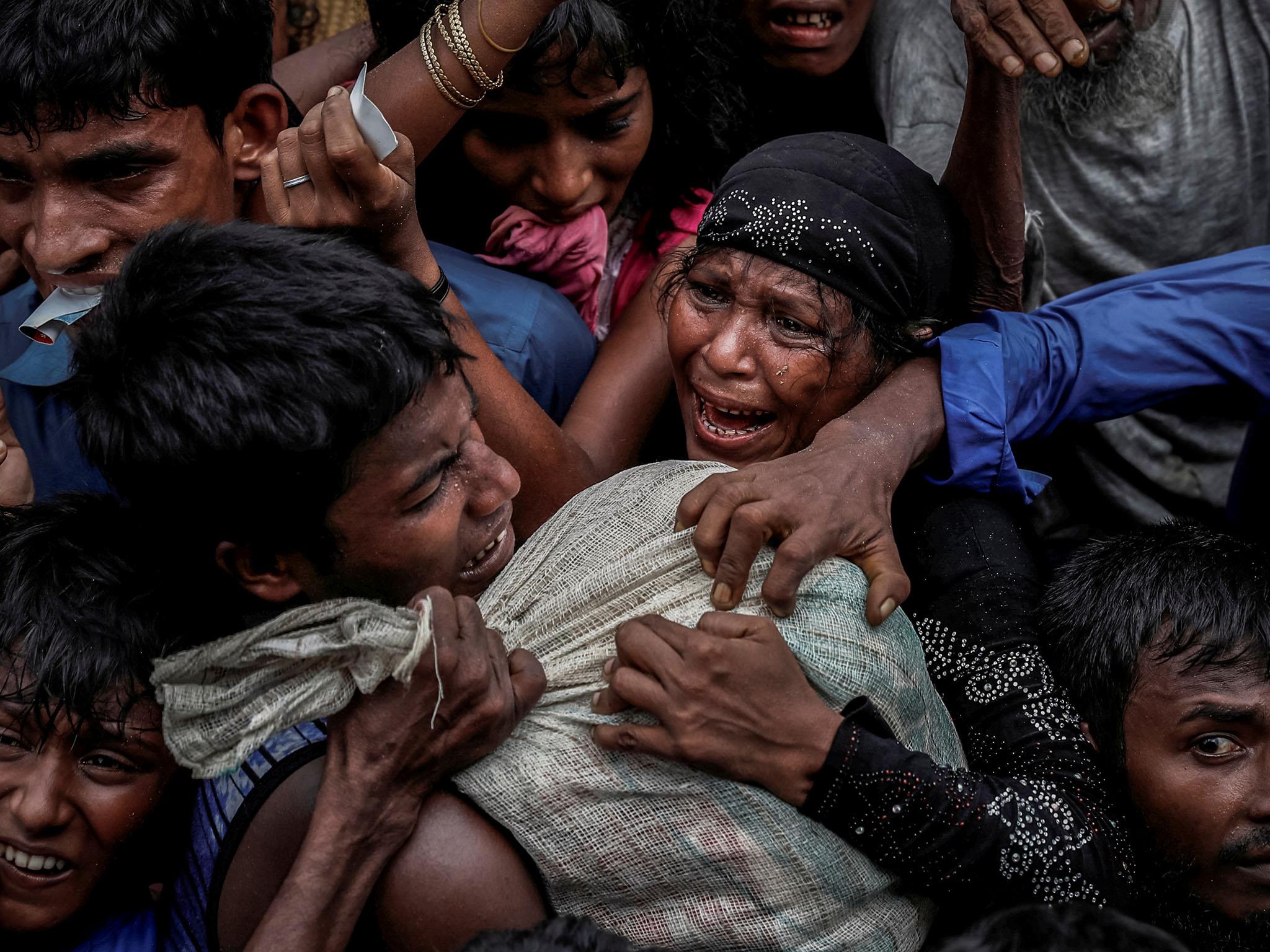 Rohingya refugees scramble for aid at a camp in Cox's Bazar (Reuters)