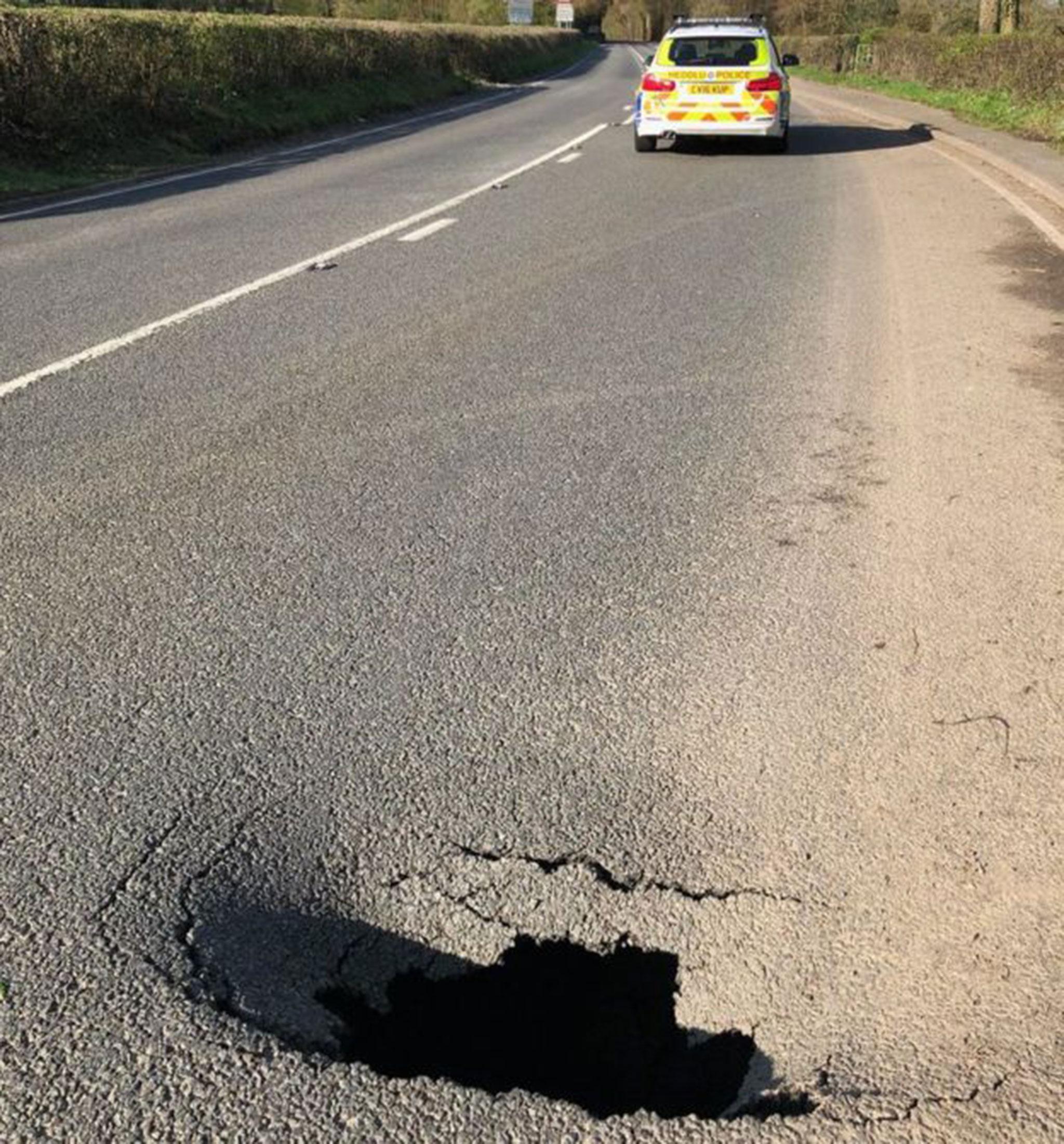 The A40 has been shut for four miles because of the hole (Dyfed-Powys Police )