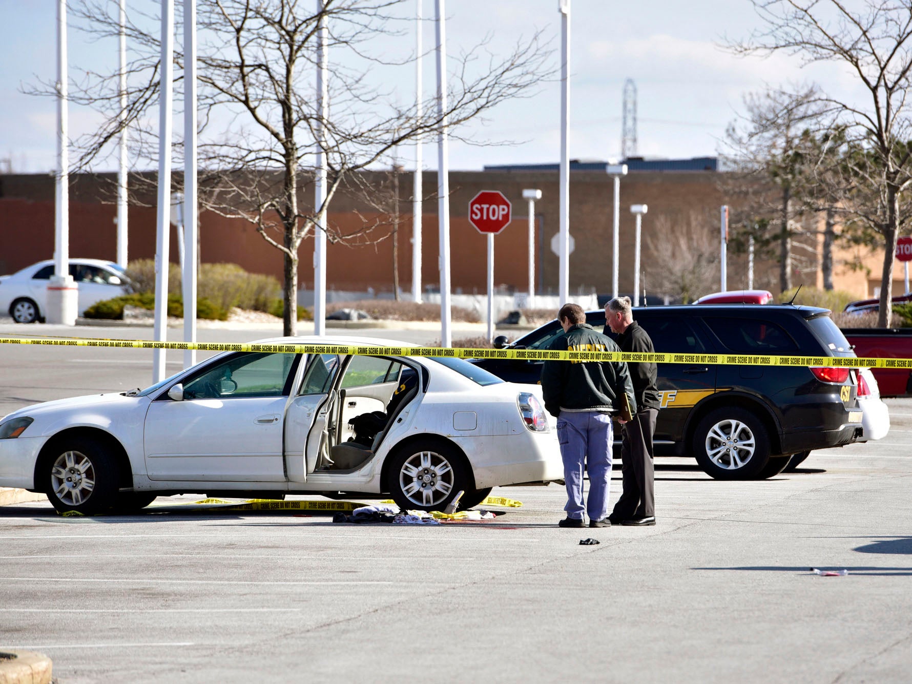 Police at the scene where a 3-year-old girl accidentally shot and wounded her pregnant mother in a car parked outside a northwestern Indiana shop