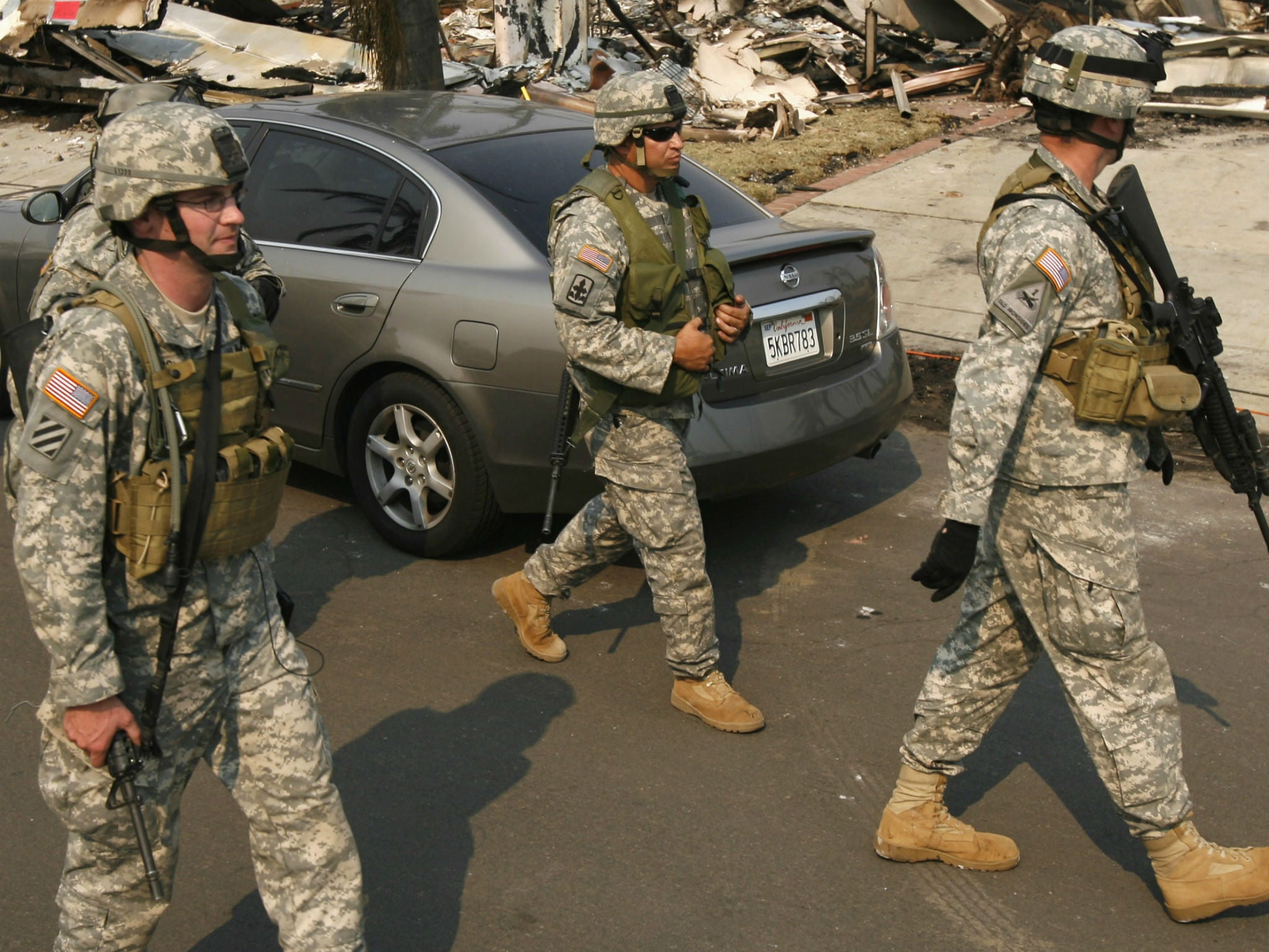 Members of the California National Guard patrol the Rancho Bernardo neighbourhood of San Diego amid a wildfire fight