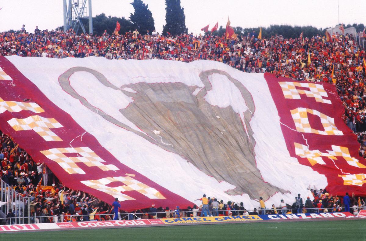 Roma fans make the most of their home advantage by unfurling a stand-sized banner.