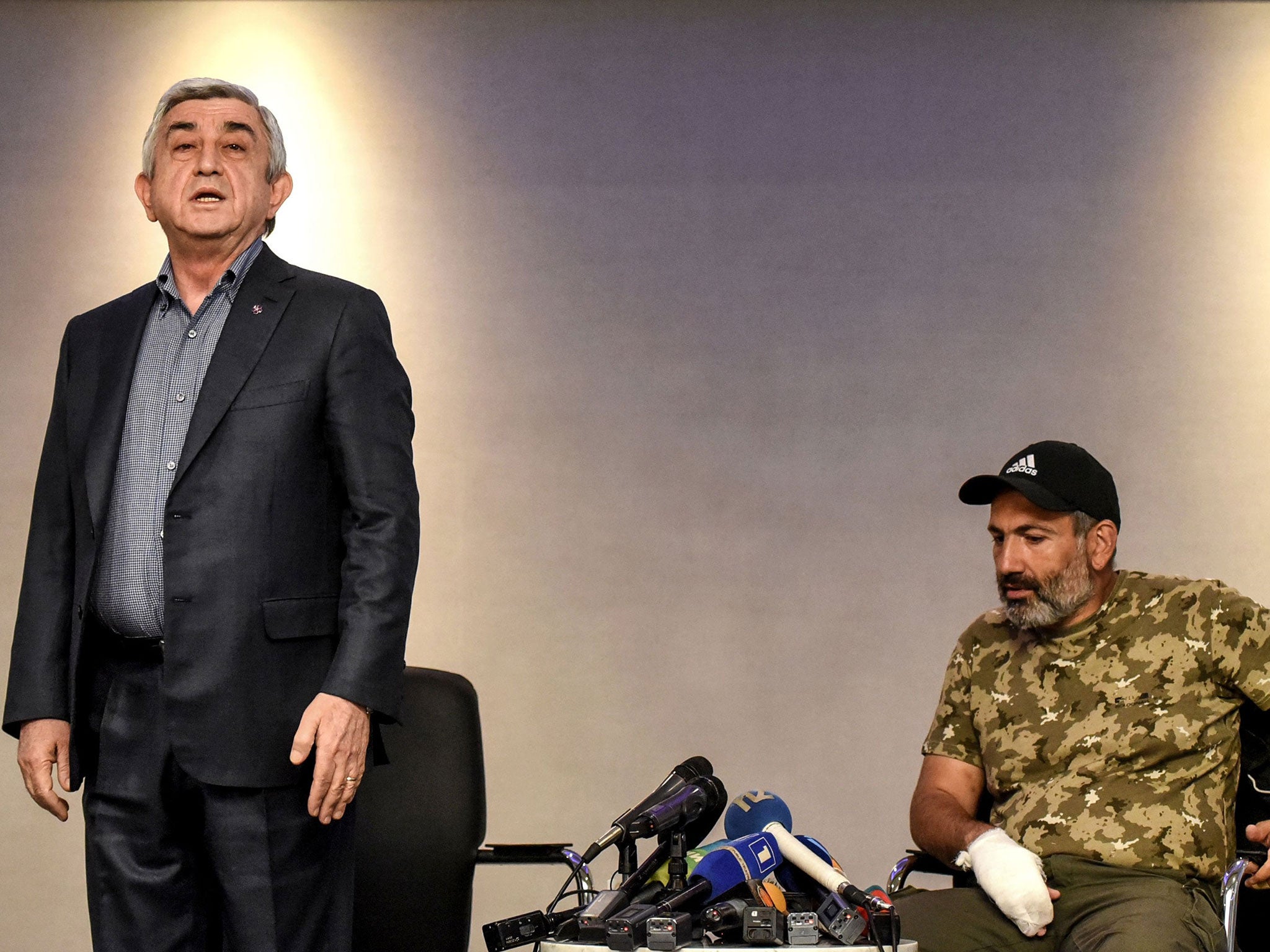 Armenia's prime minister, Serzh Sargsyan, stands before leaving a televised meeting with anti-government protest leader Nikol Pashinyan