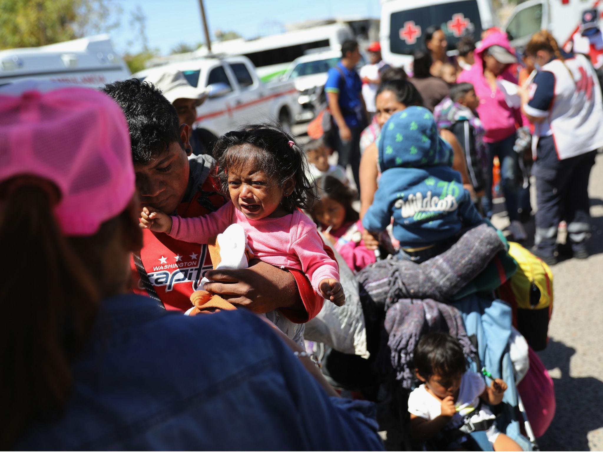 A child in the migrant caravan traveling through Mexico cries