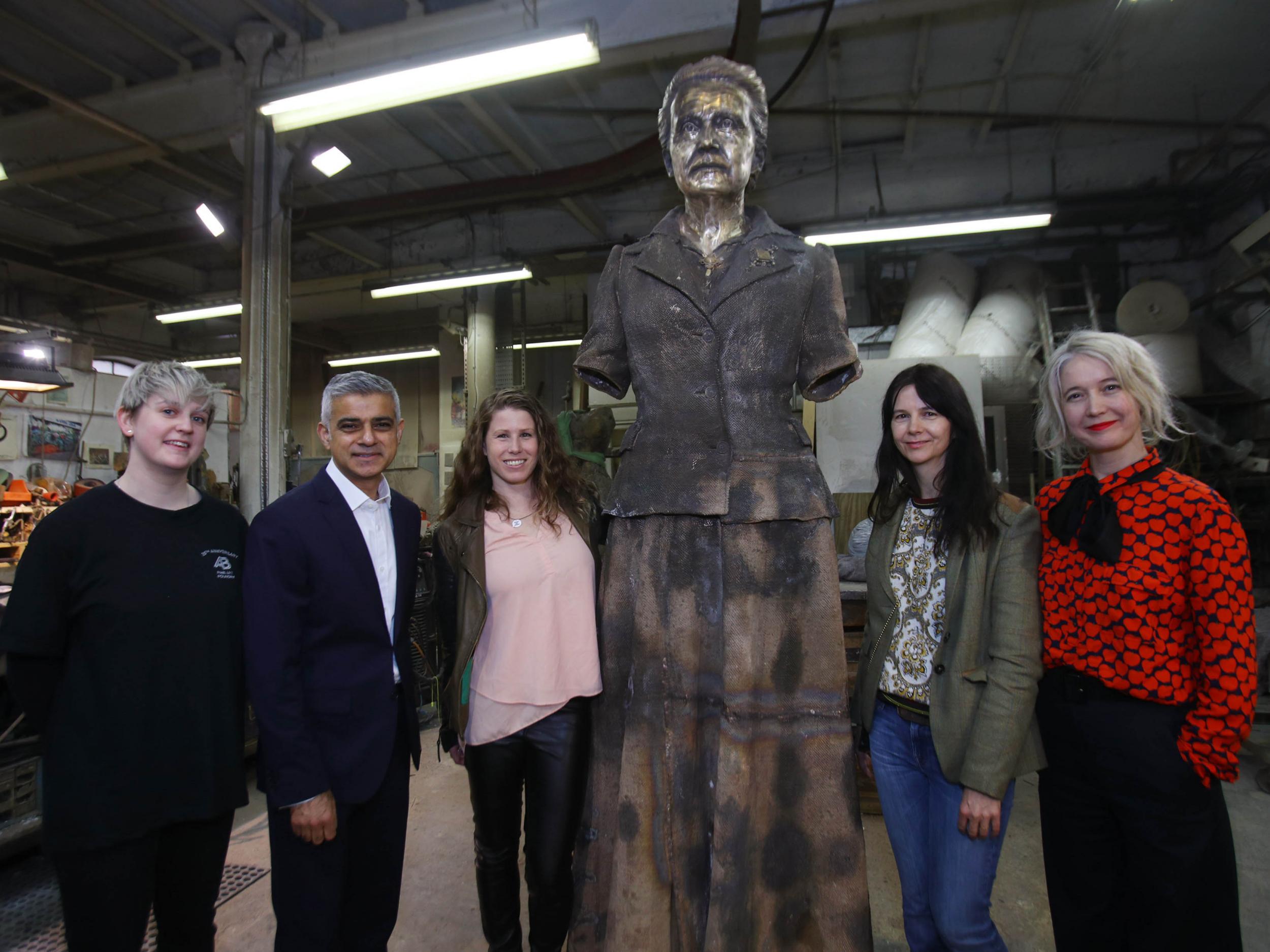 Technician Chloe Hughes, Sadiq Khan, Caroline Criado-Perez, artist Gillian Wearing and Justine Simons, during a visit to AB Fine Art Foundry in east London to see the finishing touches being put to the artwork