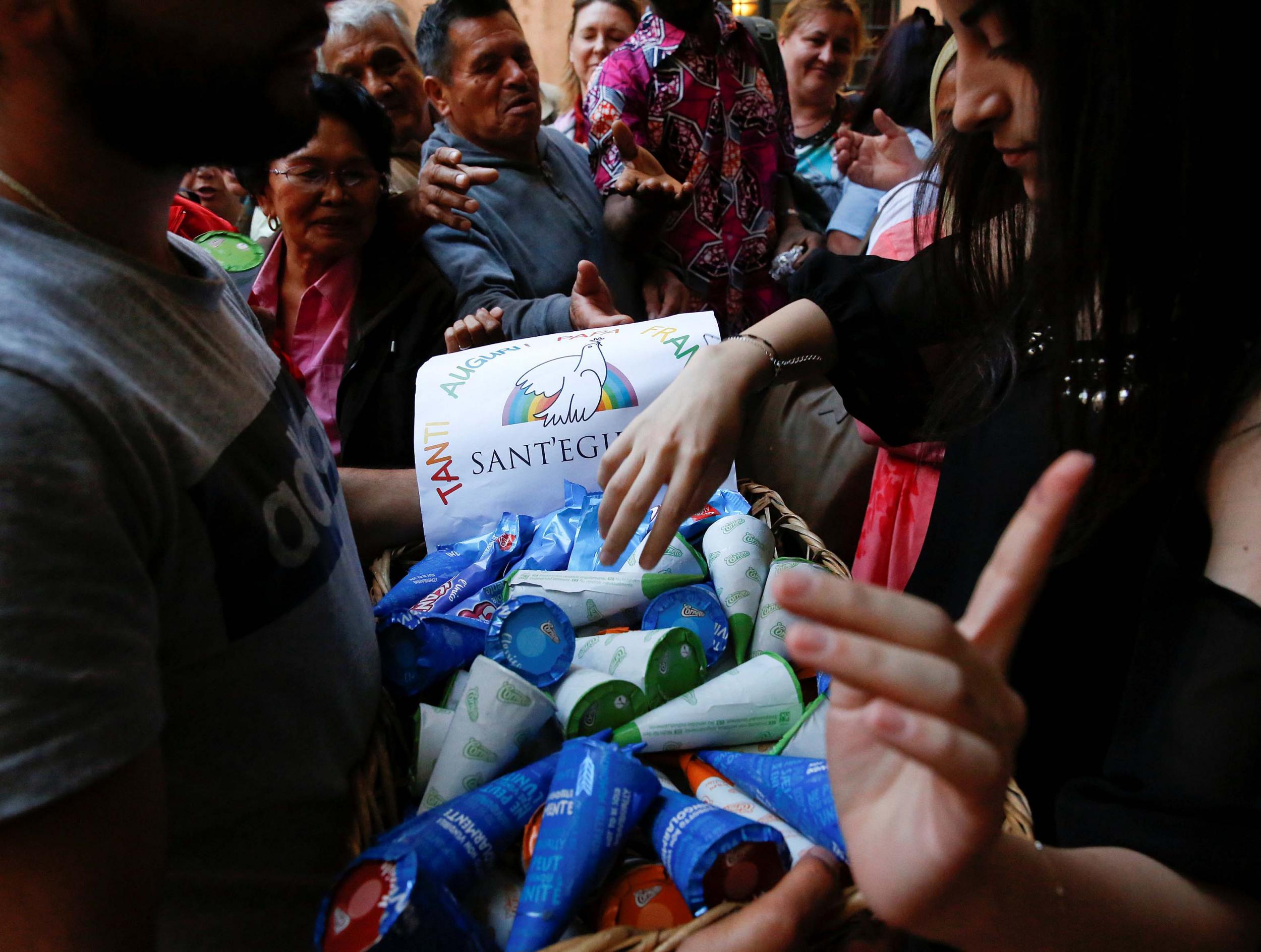 Charity workers distribute ice creams to guests at a community centre in Rome