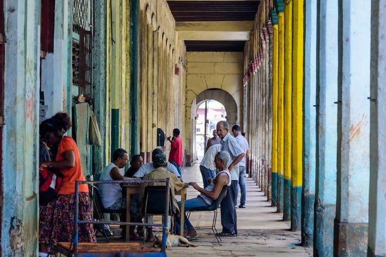 Join a game of dominoes with the locals and grab some authentic street food in the Diez de Octubre