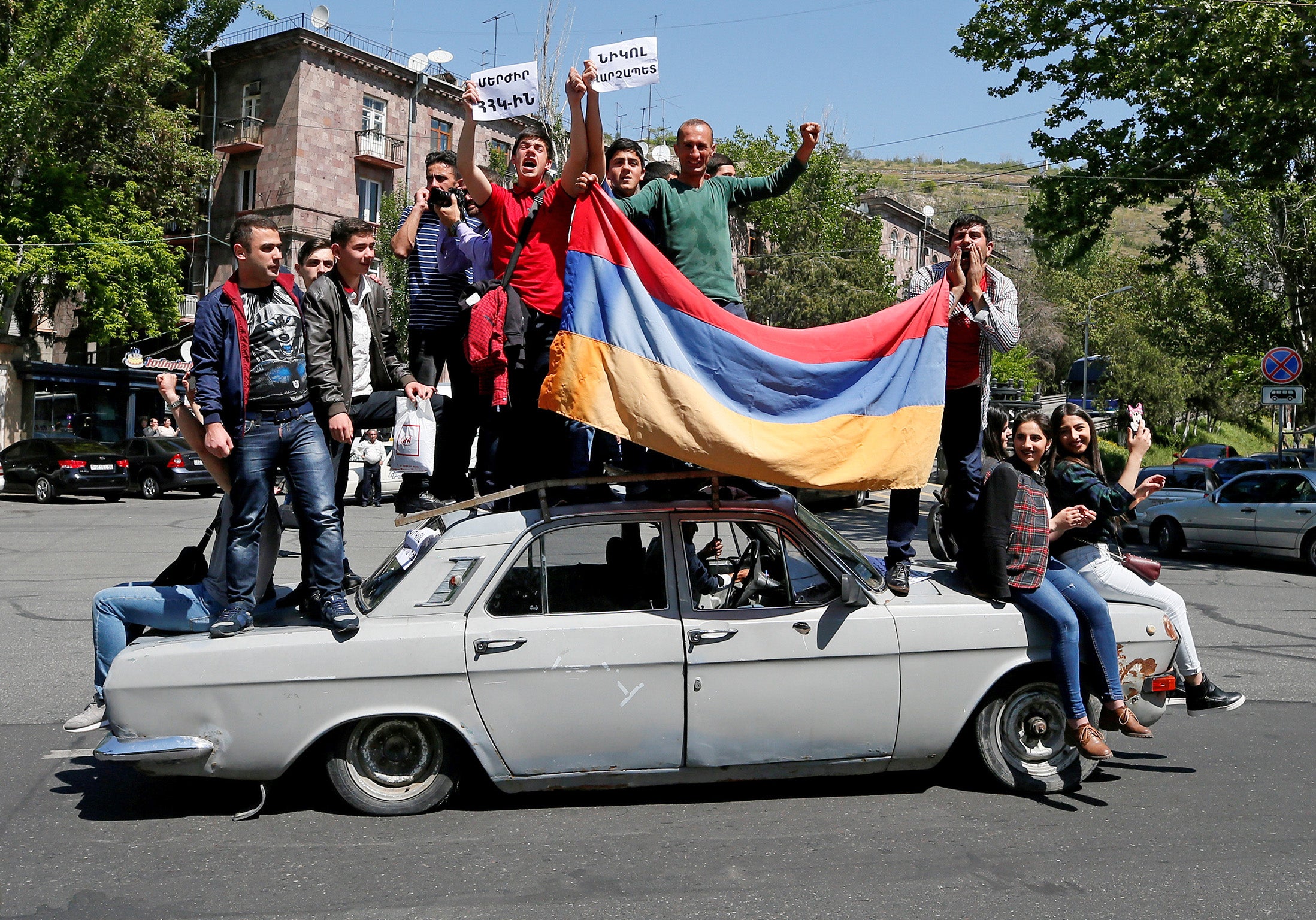 Supporters of Armenian opposition leader Nikol Pashinyan drive a car during a rally in Yerevan, Armenia