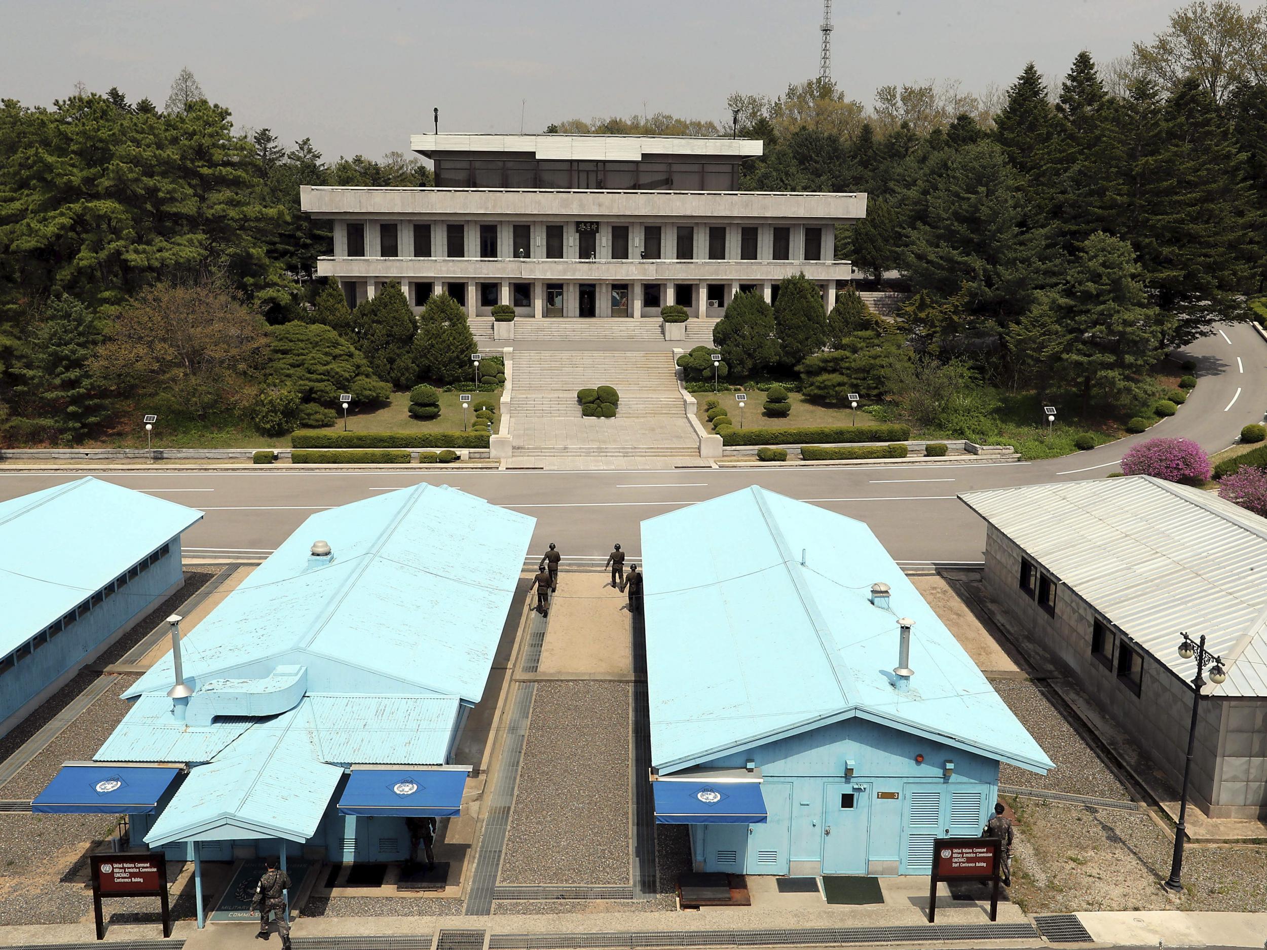 North Korean soldiers, centre, and South Korean soldiers, bottom, at the border village of Panmunjom in the Demilitarized Zone