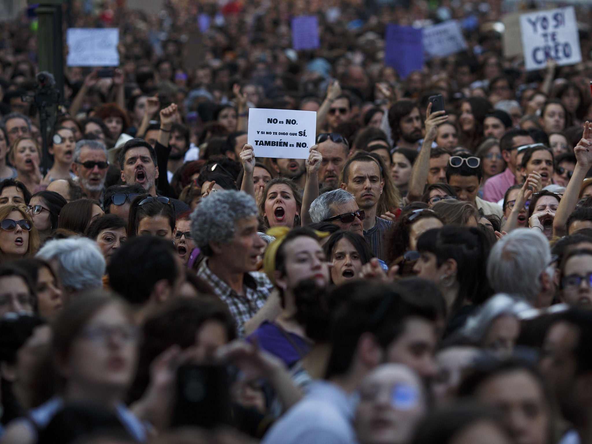 A protester in Madrid holds a placard reading 'No is no. If I don't tell you yes, it is also no' during a demonstration against the ‘wolf pack’ sentences