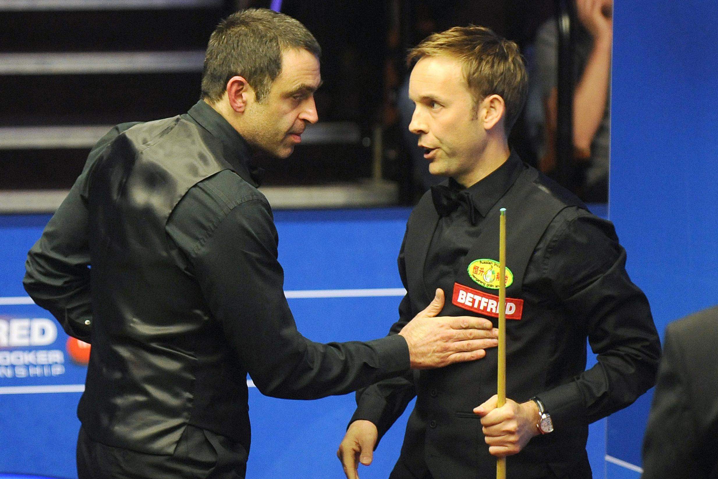 Ronnie O'Sullivan congratulates Ali Carter after their feisty encounter