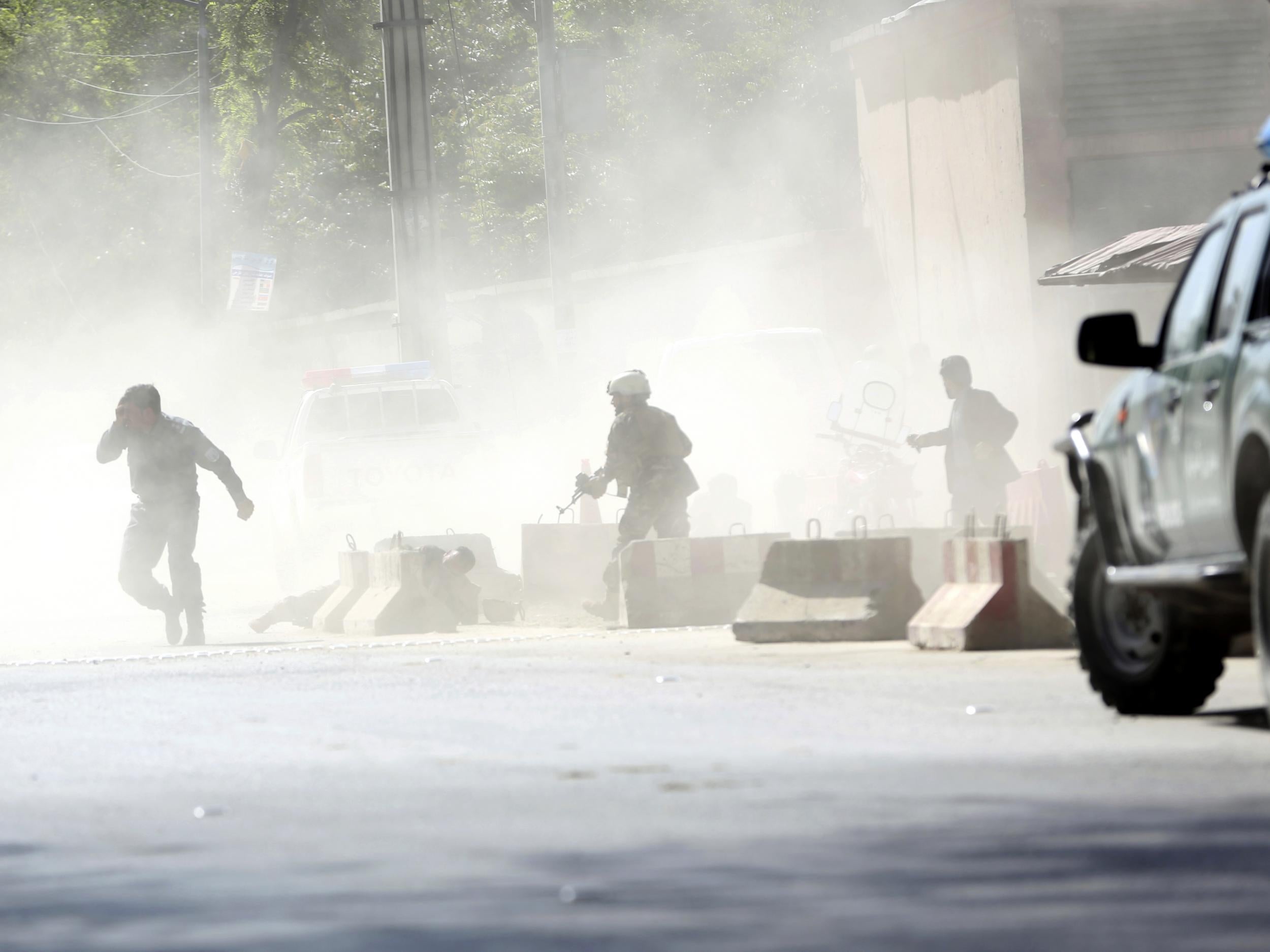 Security forces run from the site of a suicide attack in Kabul, Afghanistan, on Monday 30 April 2018