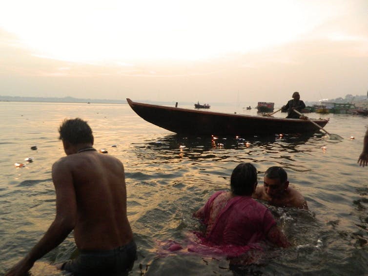 Boatmen setting out at sunrise