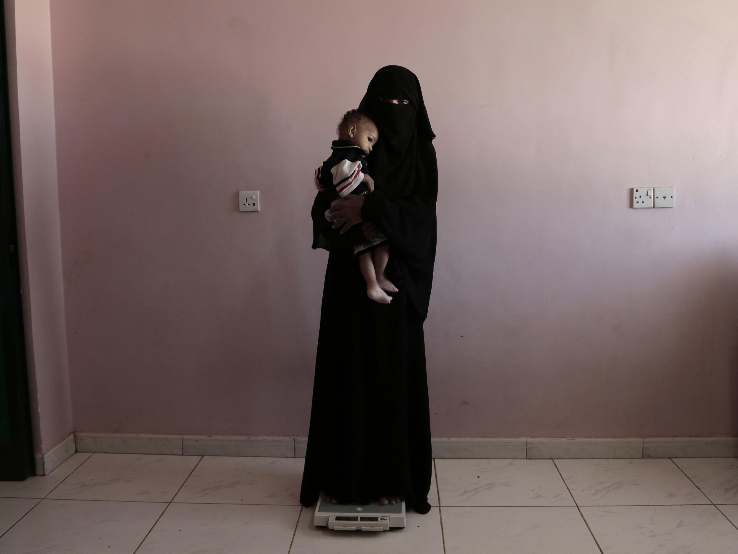 Umm Mizrah on the scales at the hospital. She and her husband, who have three young daughters in addition to Mizrah, usually eat one meal a day, often just bread and tea