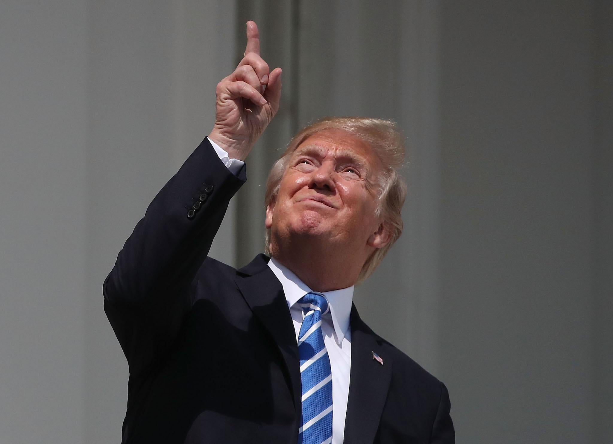 U.S. President Donald Trump looks up toward the Solar Eclipse on the Truman Balcony at the White House on August 21, 2017 in Washington, DC