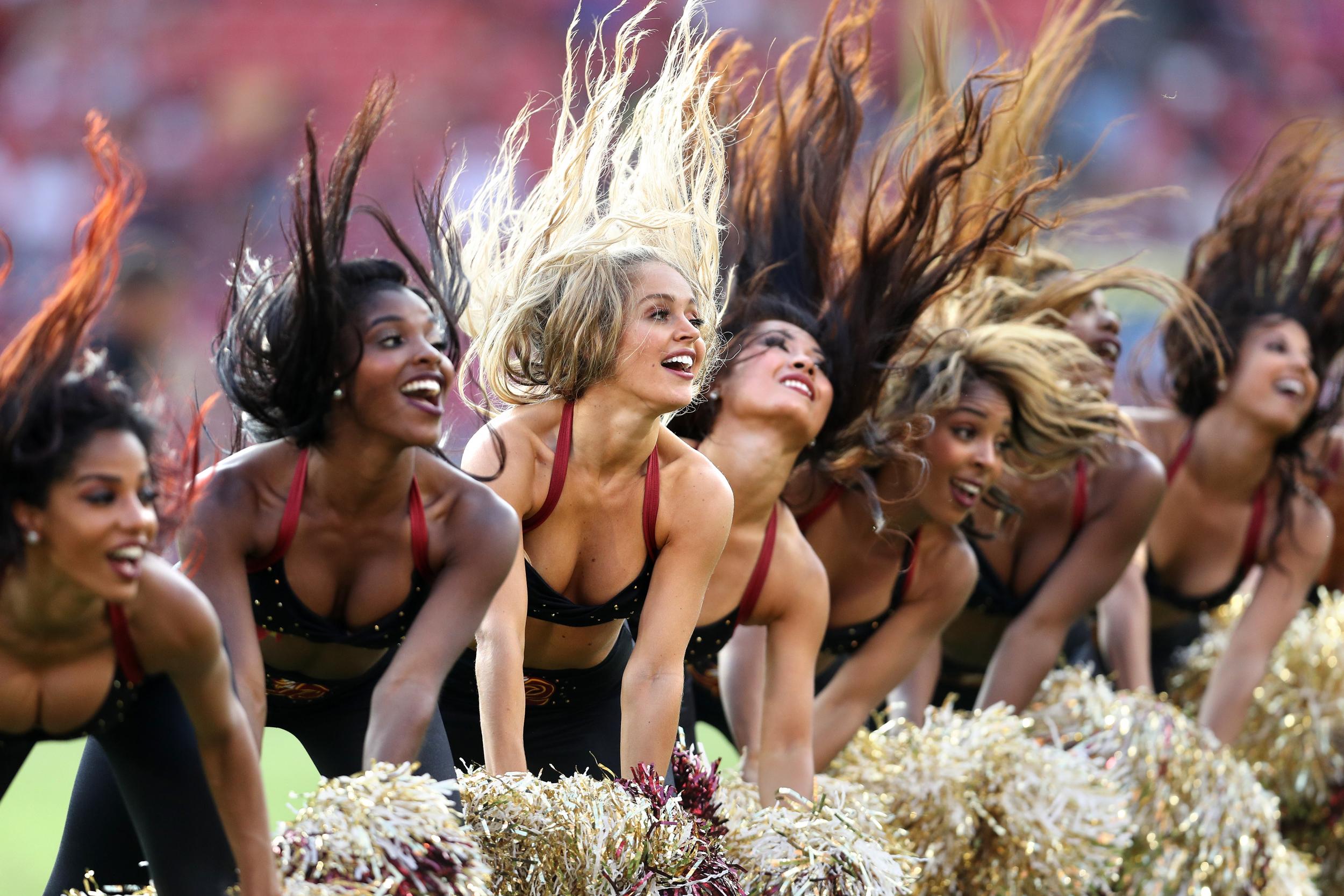 Cheerleaders, such as these Washington Redskins, are rarely paid much more than minimum wage (Getty)