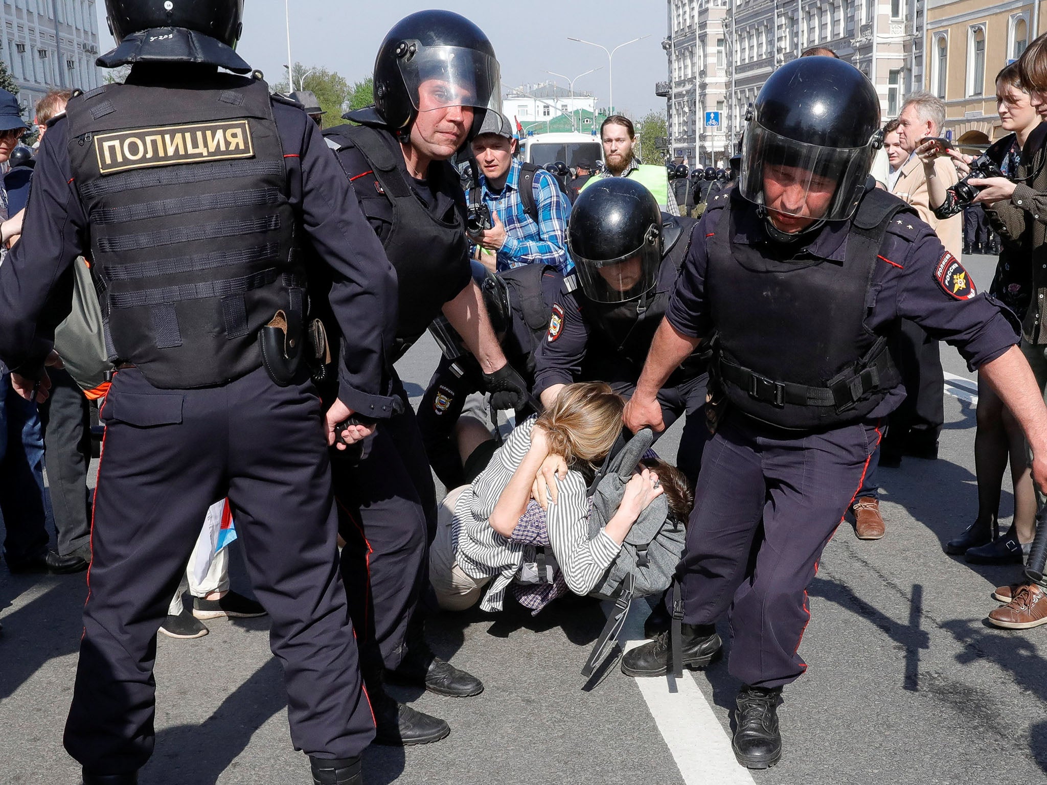 Policemen detain opposition supporters (Reuters)