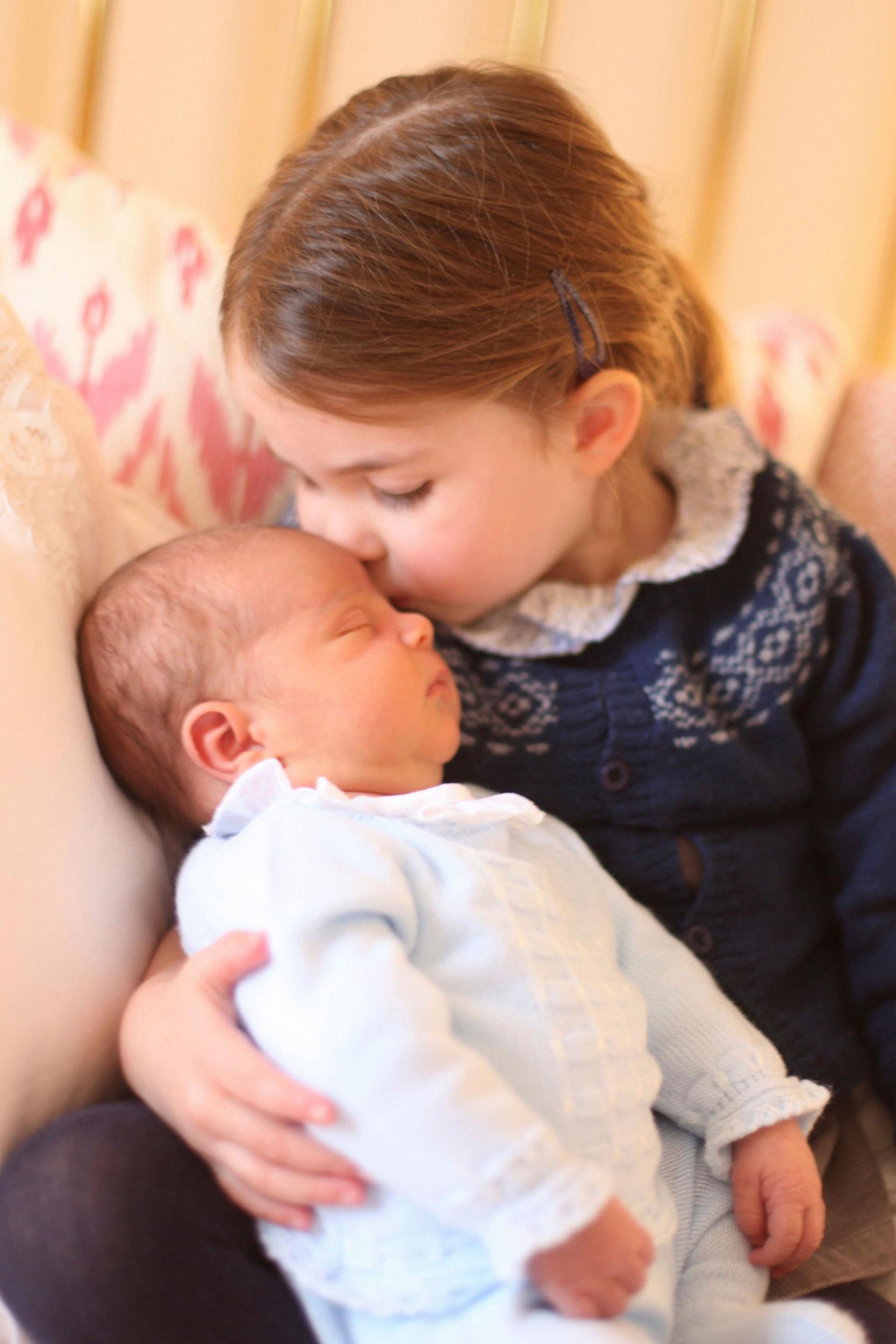 Princess Charlotte cuddles her brother Prince Louis