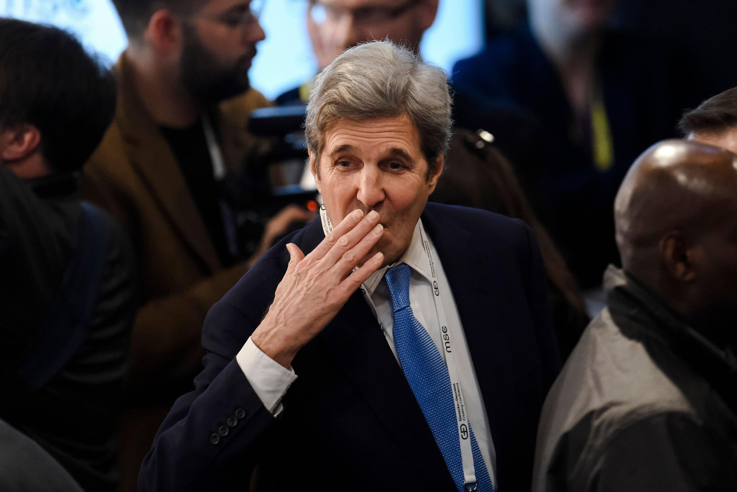 Former US secretary of state John Kerry greets somebody during the 54th Munich Security Conference