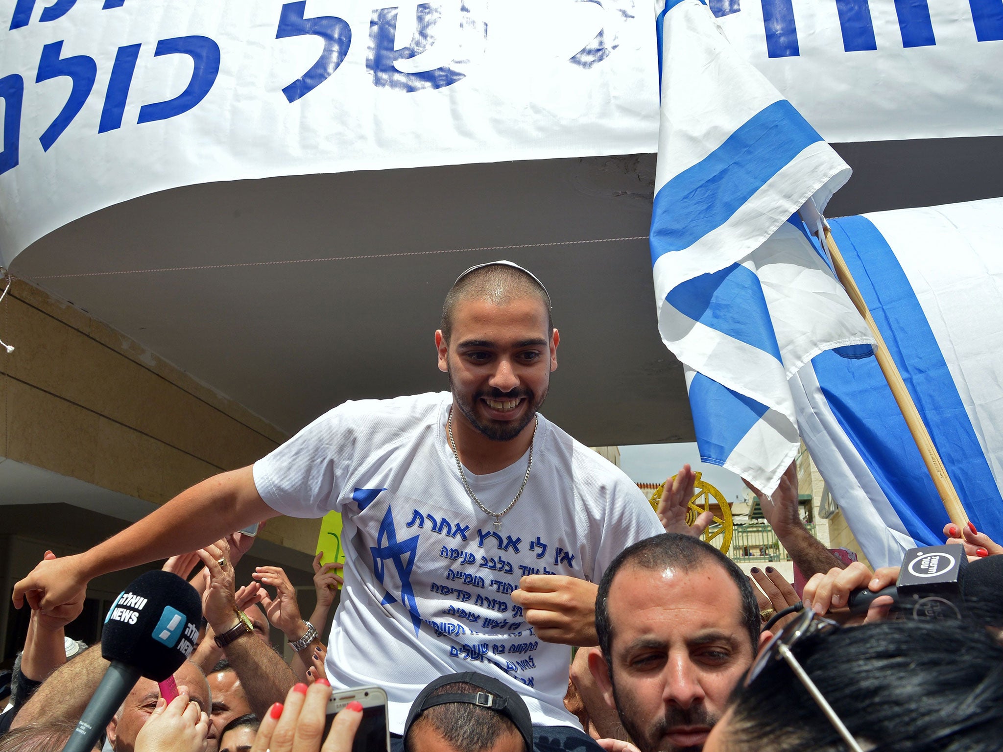 Israeli soldier Elor Azaria is lifted by friends near his family home in Ramla, near Tel Aviv, as they celebrate his release from prison