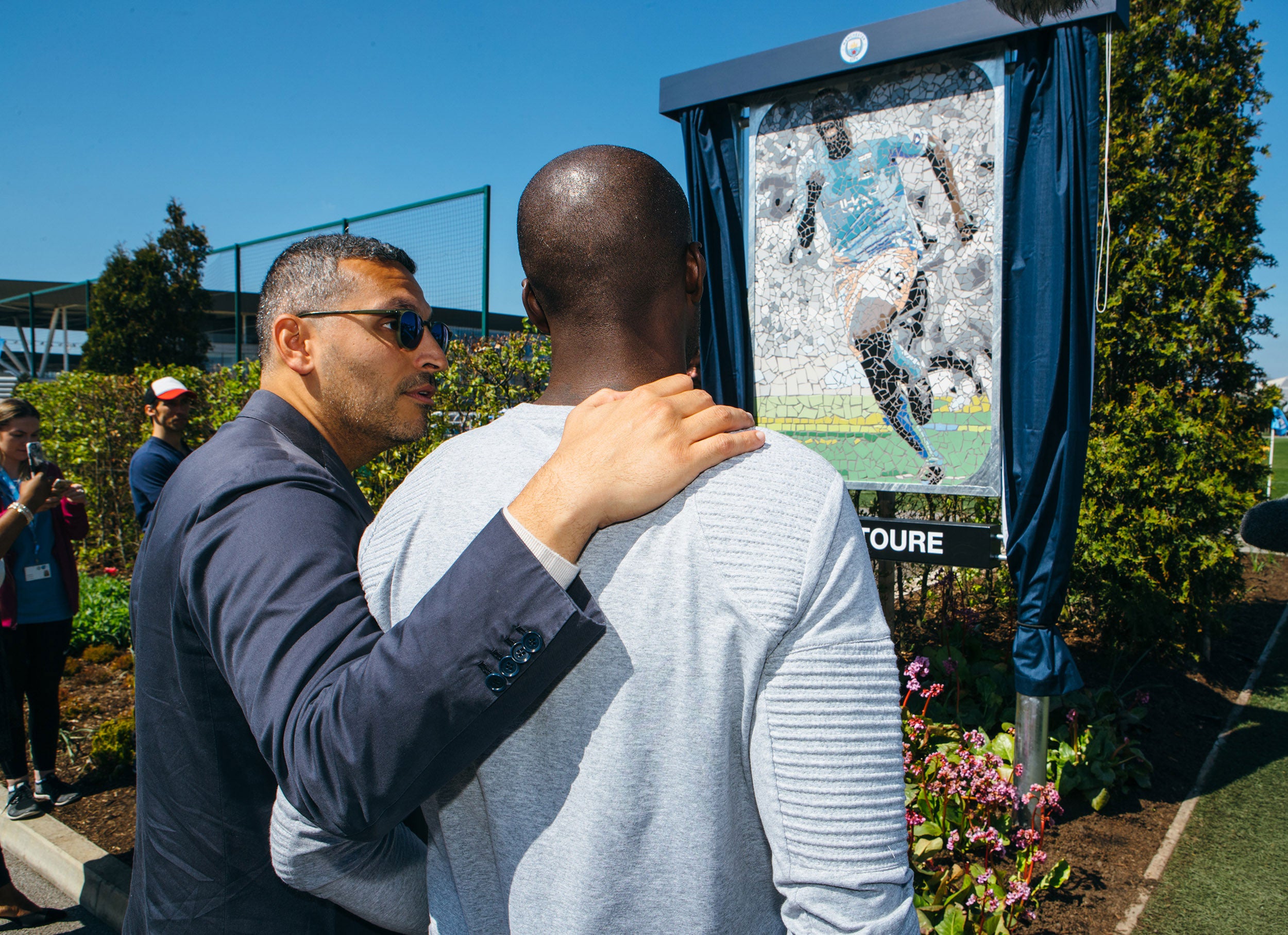 Manchester City chairman Khaldoon Al Mubarak joins Yaya Toure at the City Football Academy to rename a pitch at the club’s training ground after the midfielder. Al Mubarak unveiled a Yaya-inspired mosaic besides the training pitch to celebrate Toure’s eight years at the club ahead of his final game at the Etihad on Wednesday night.