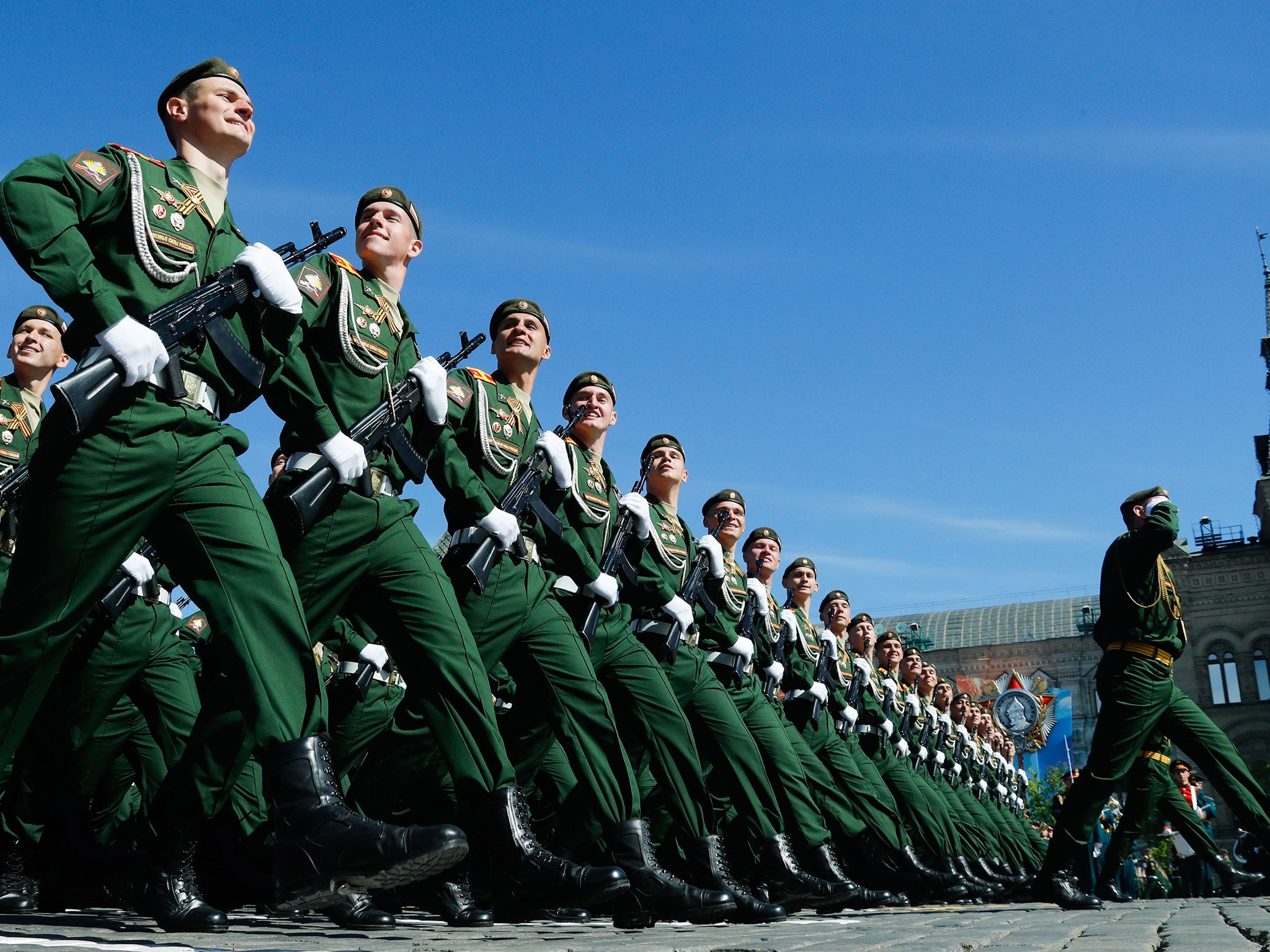 Servicemen march in formation during a Victory Day military parade