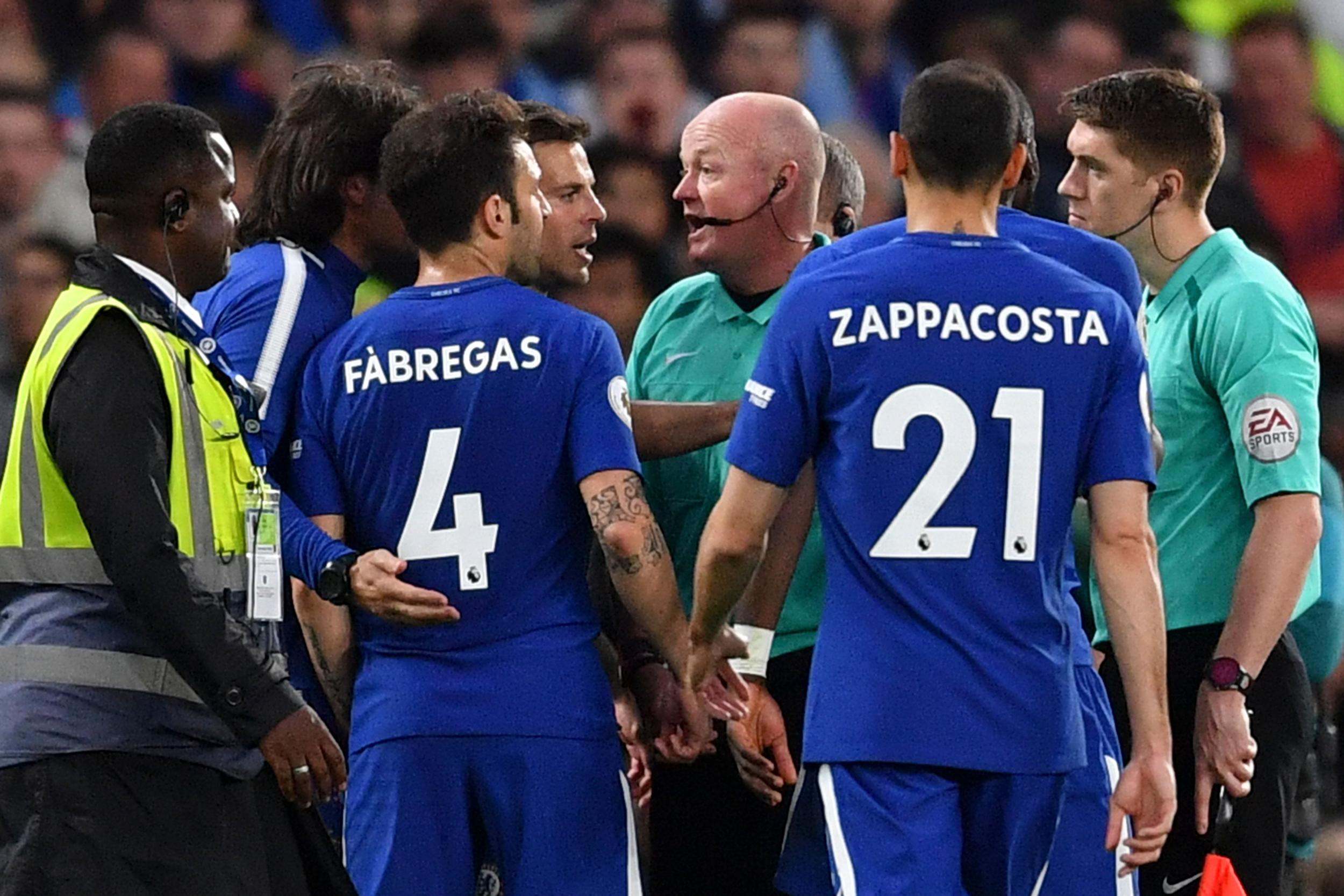 Chelsea players surround the referee