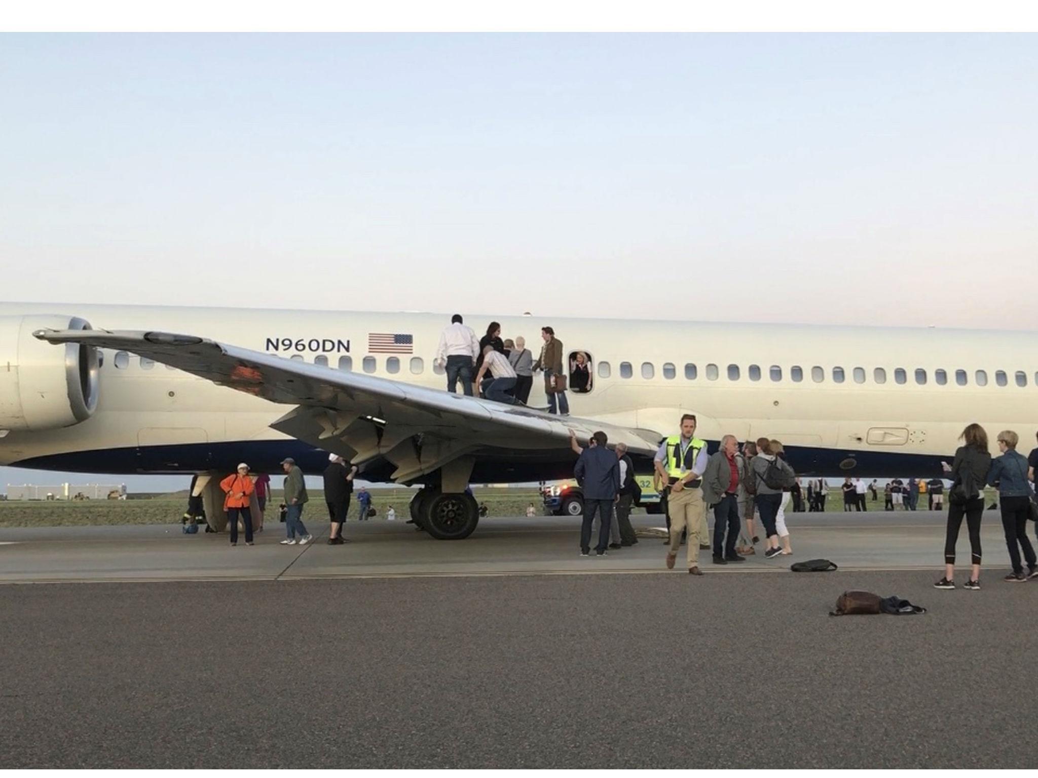 Passengers rushed to leave the aircraft after it filled with a 'dizzying' smoke