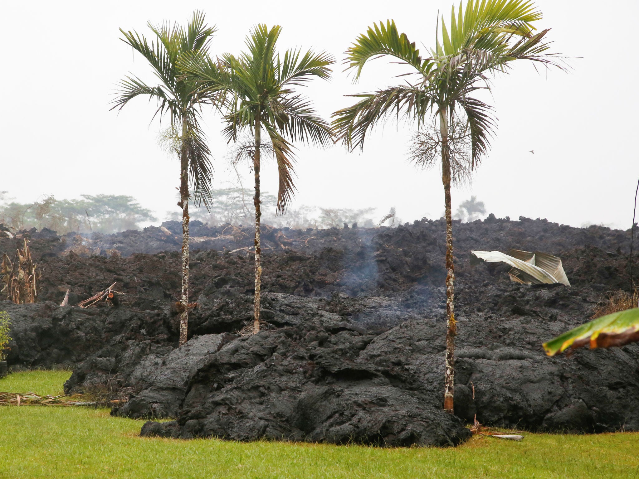 Lava cools in a resident's yard in the Leilani Estates subdivision during ongoing eruptions of the Kilauea Volcano in Hawaii