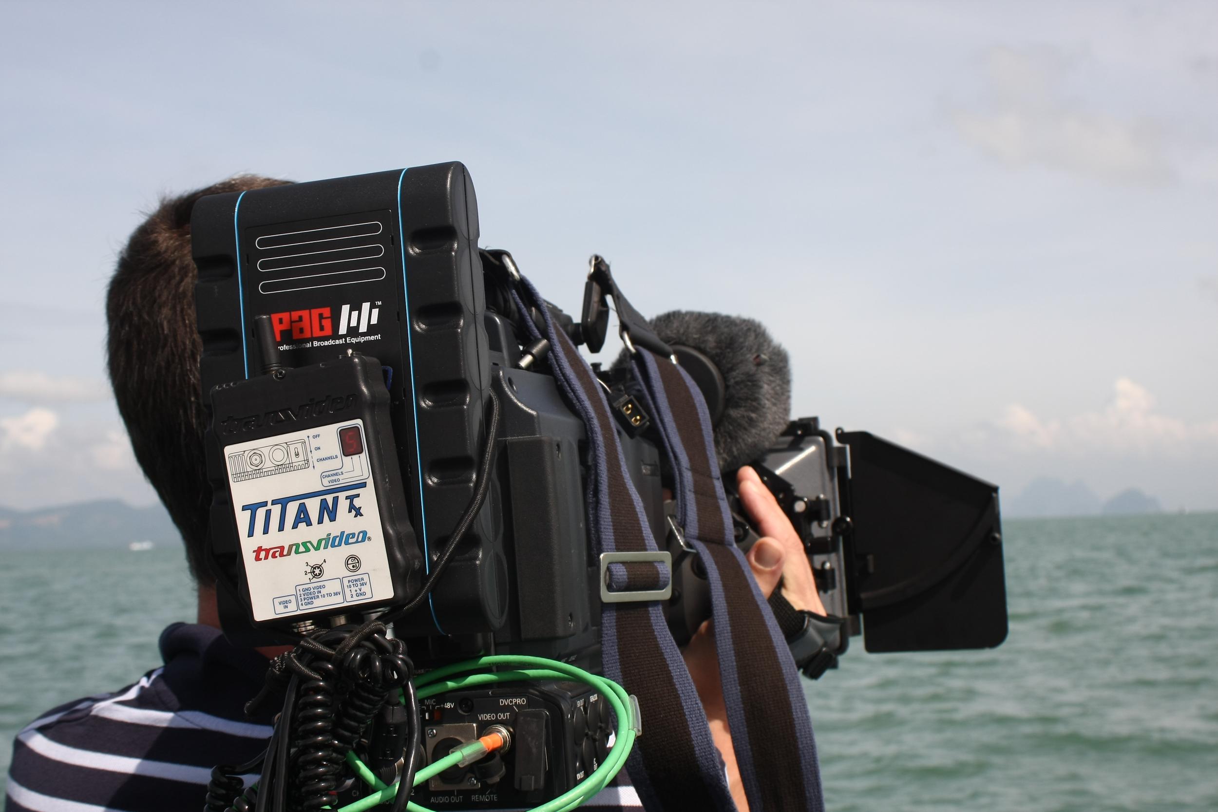 Now that’s what I call a battery: a cameraman on the Thai island of Phuket