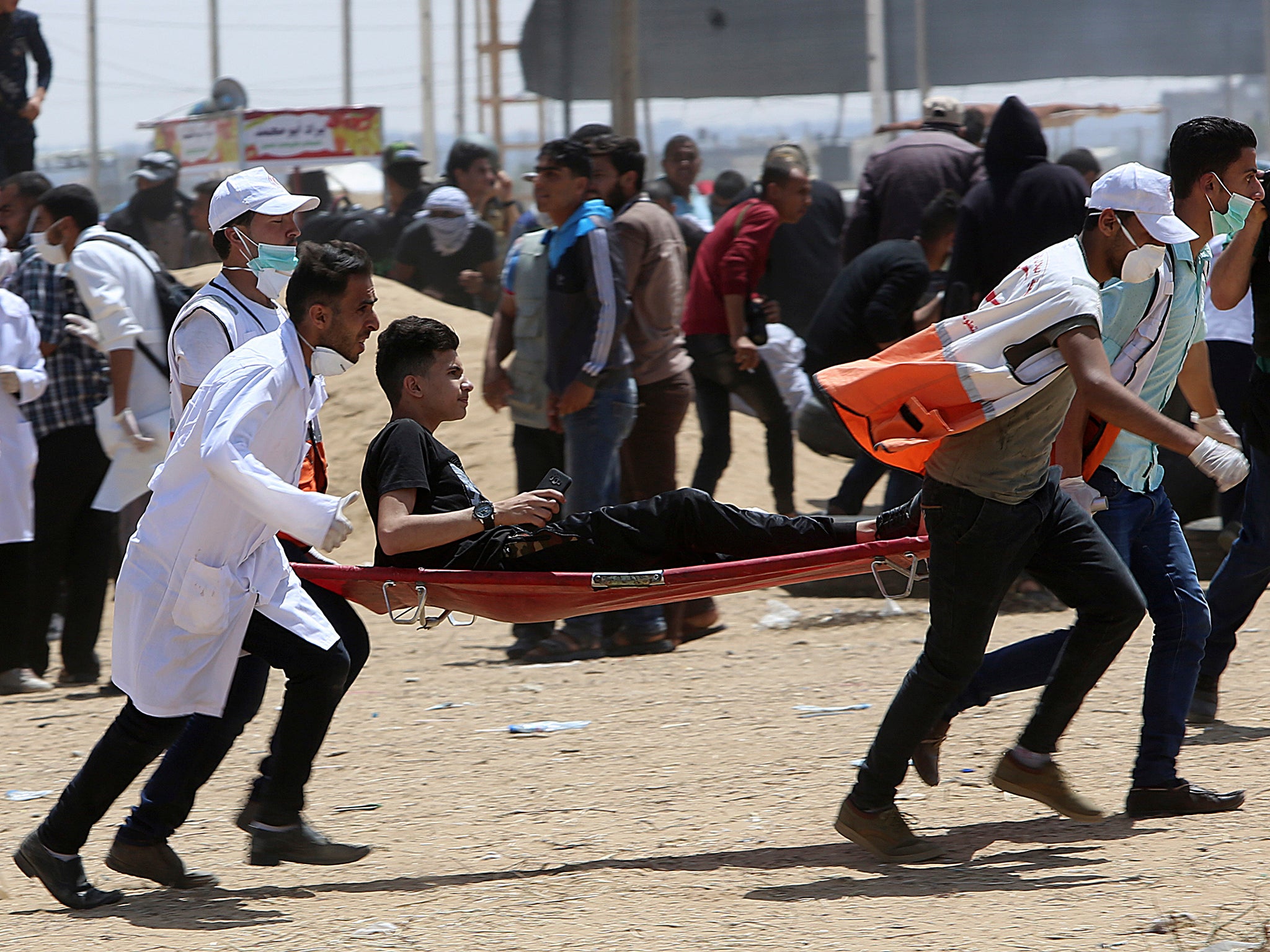 Palestinian medics evacuate a wounded protester on Friday