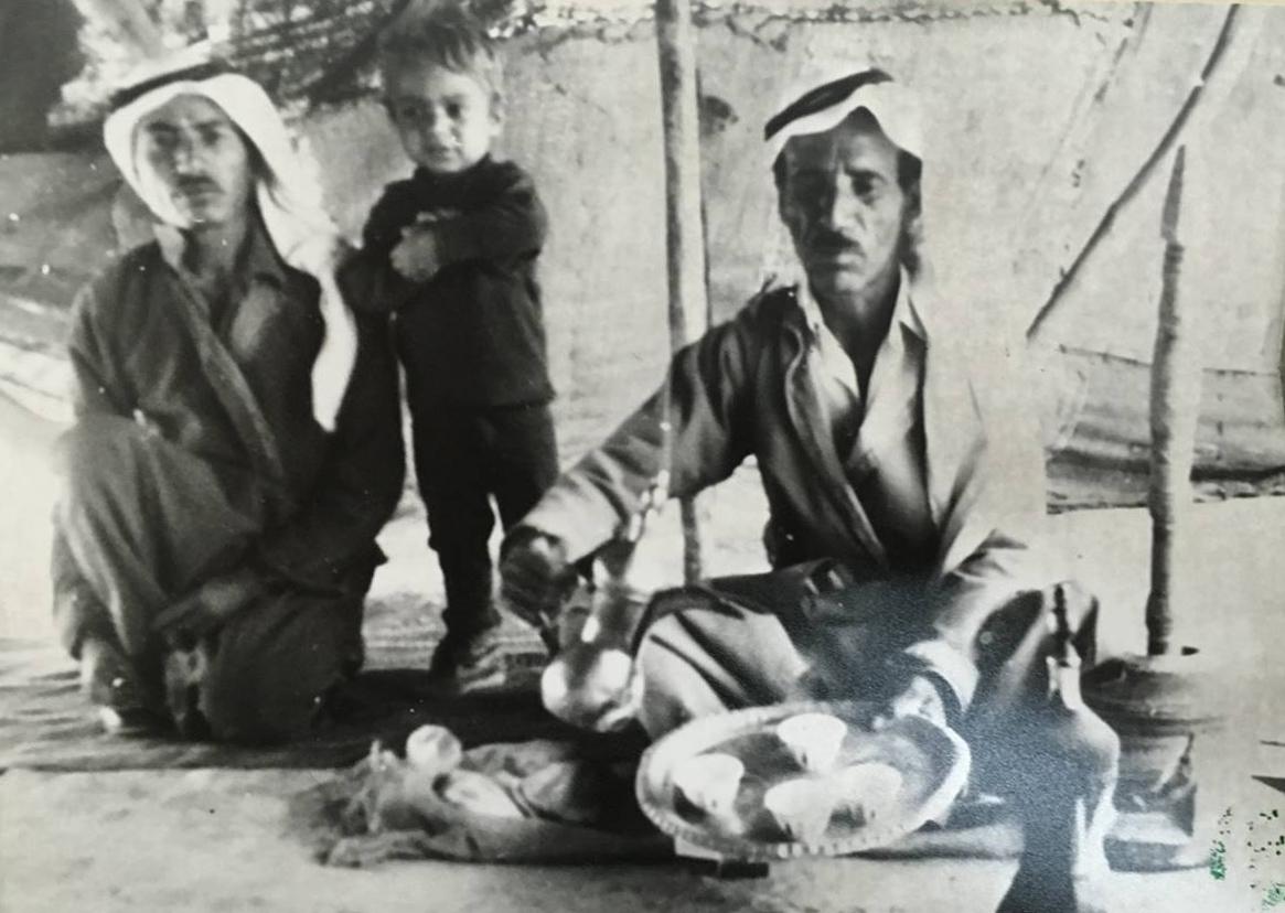 Arab villagers from a destroyed village near Gaza offer cake to a Jewish visitor from a nearby settlement. The visitor took the picture