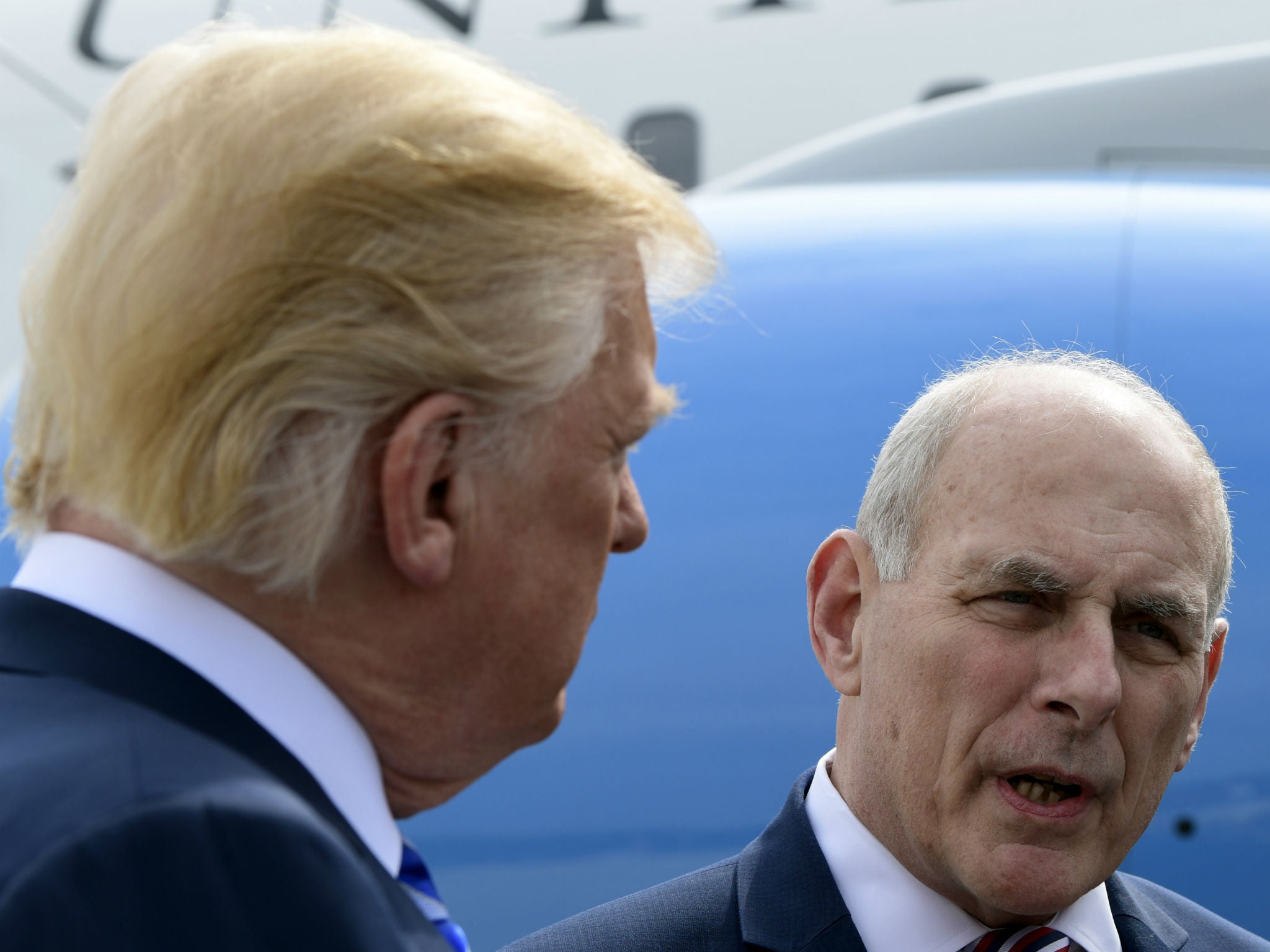 White House Chief of Staff John Kelly speaks to reporters as Donald Trump listens before boarding Air Force One