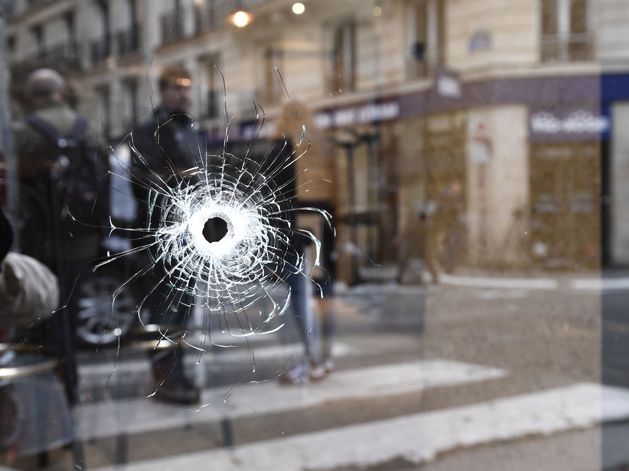 A bullet hole on the window of a cafe located at the crossroads between the streets where one man was killed four others injured (AFP/Getty)