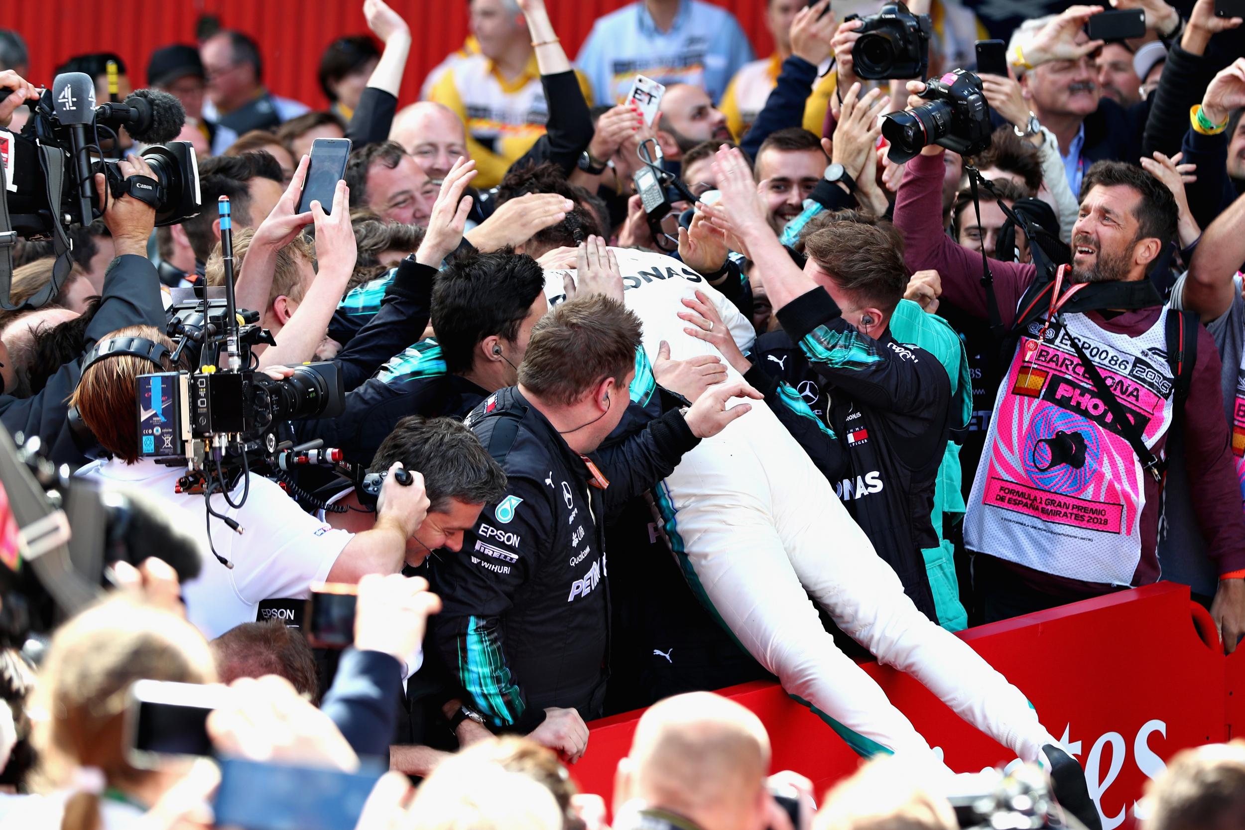 Lewis Hamilton celebrates with his Mercedes team