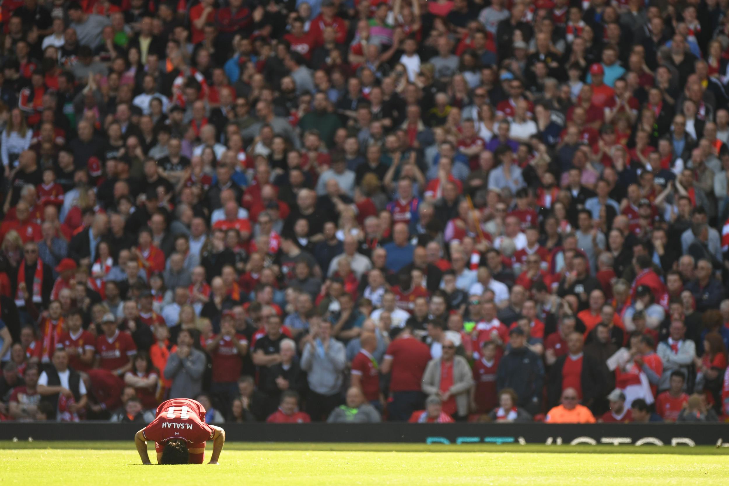 Mohamed Salah kisses the turf after scoring