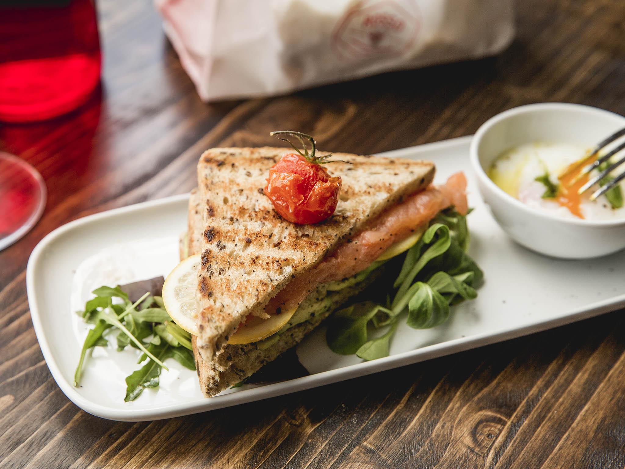 Smoked salmon and avocado club sandwich comes with a side of eggs, cooked how you like them