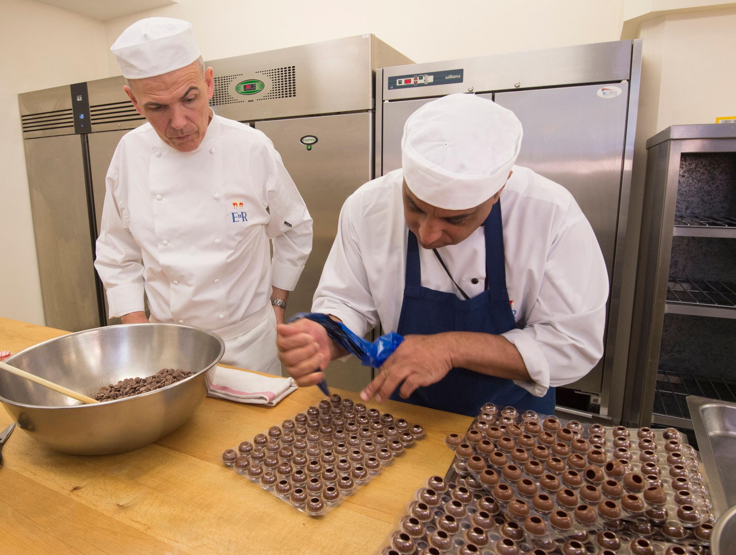 Head chef Mark Flanagan oversees pastry chef Selwyn Stoby as he creates chocolate truffles in preparation for the royal wedding.