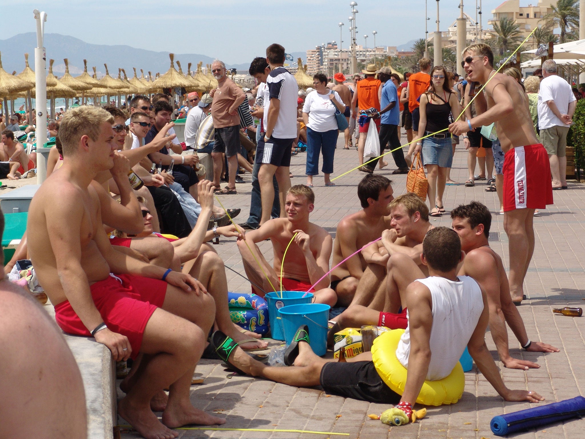 Young men drinking alcohol from buckets in Mallorca