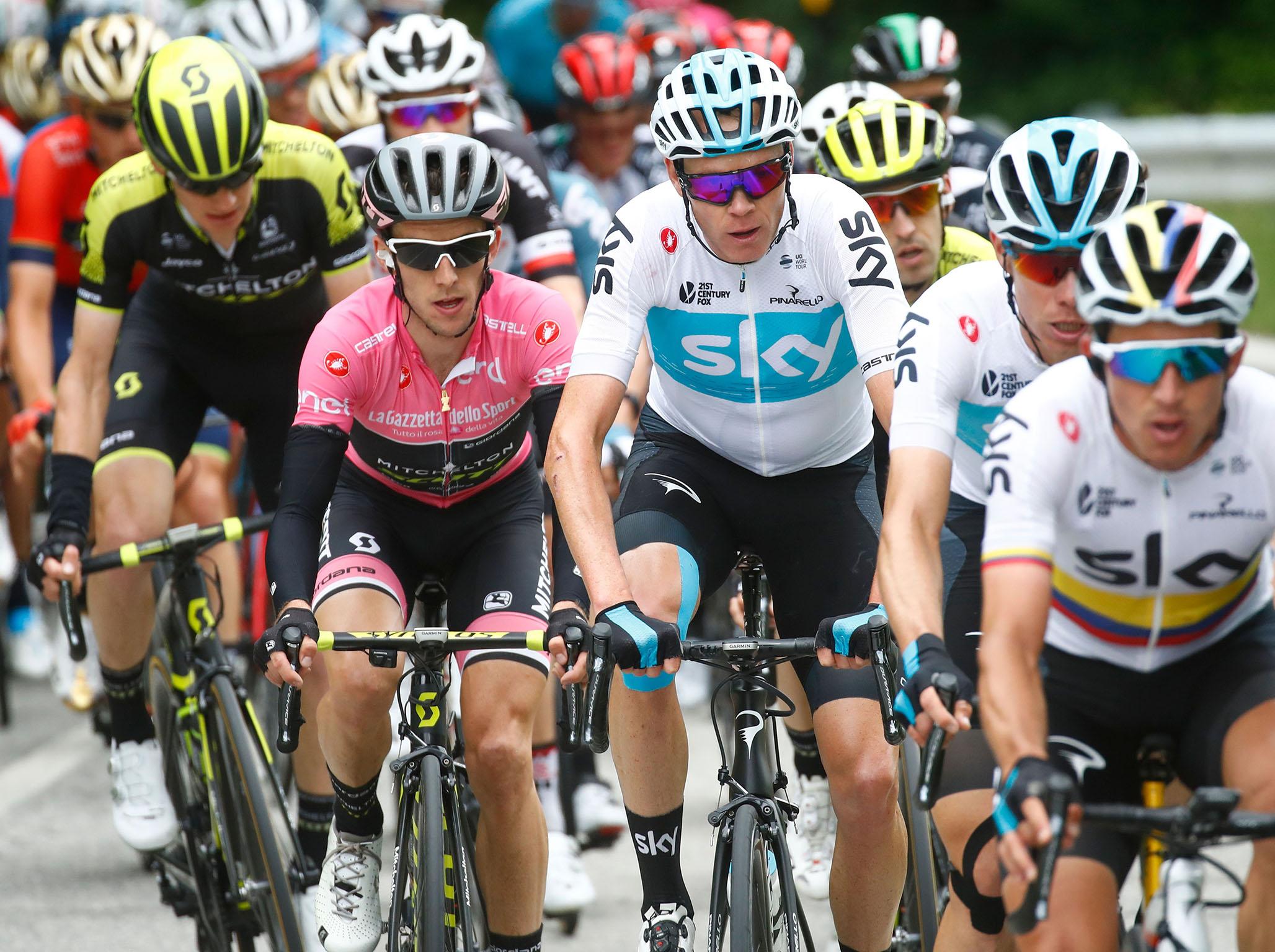 Simon Yates rides in the pack behind Team Sky's Chris Froome