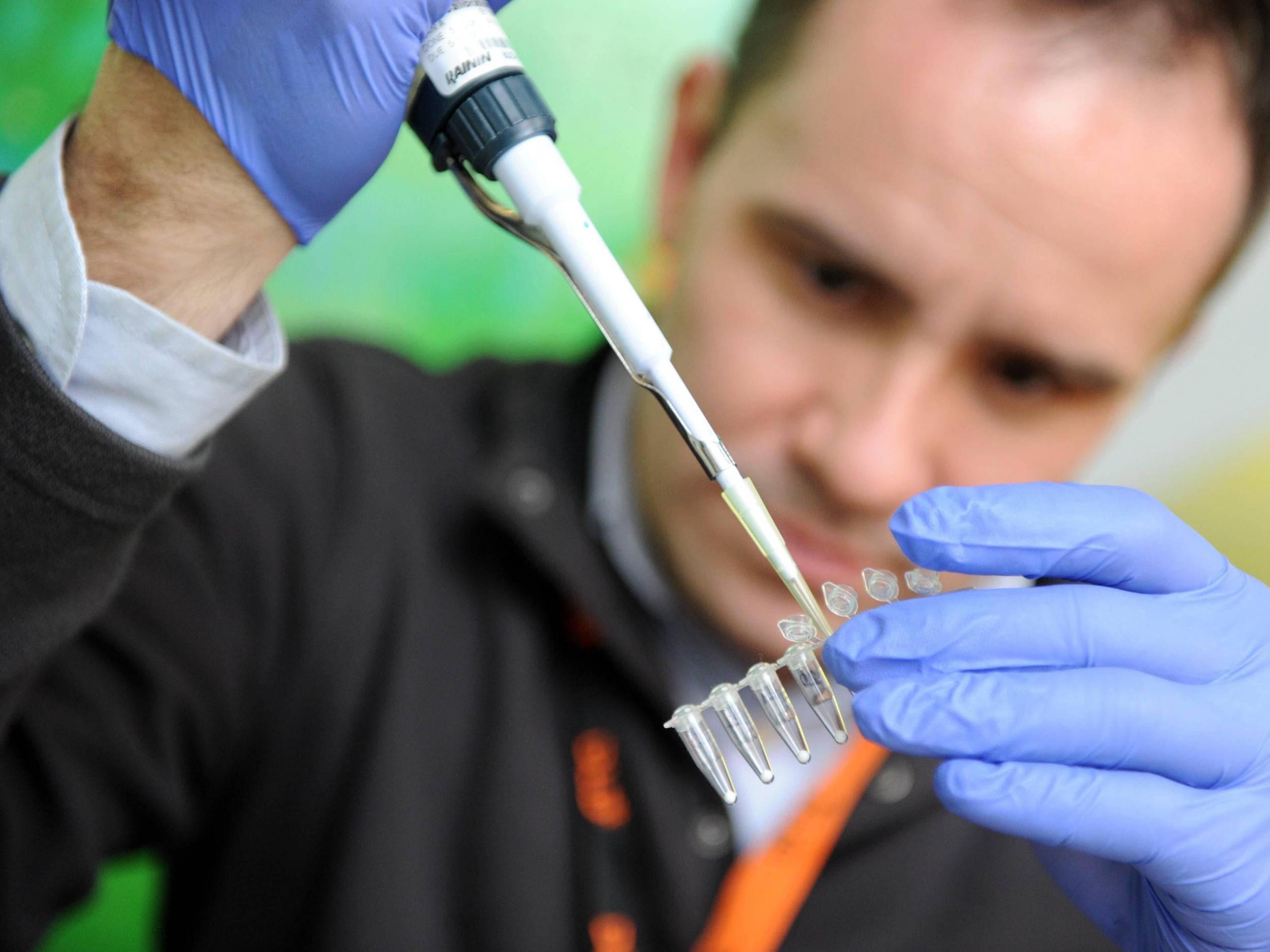 A Genspace researcher puts DNA into a tube during a conference in Germany